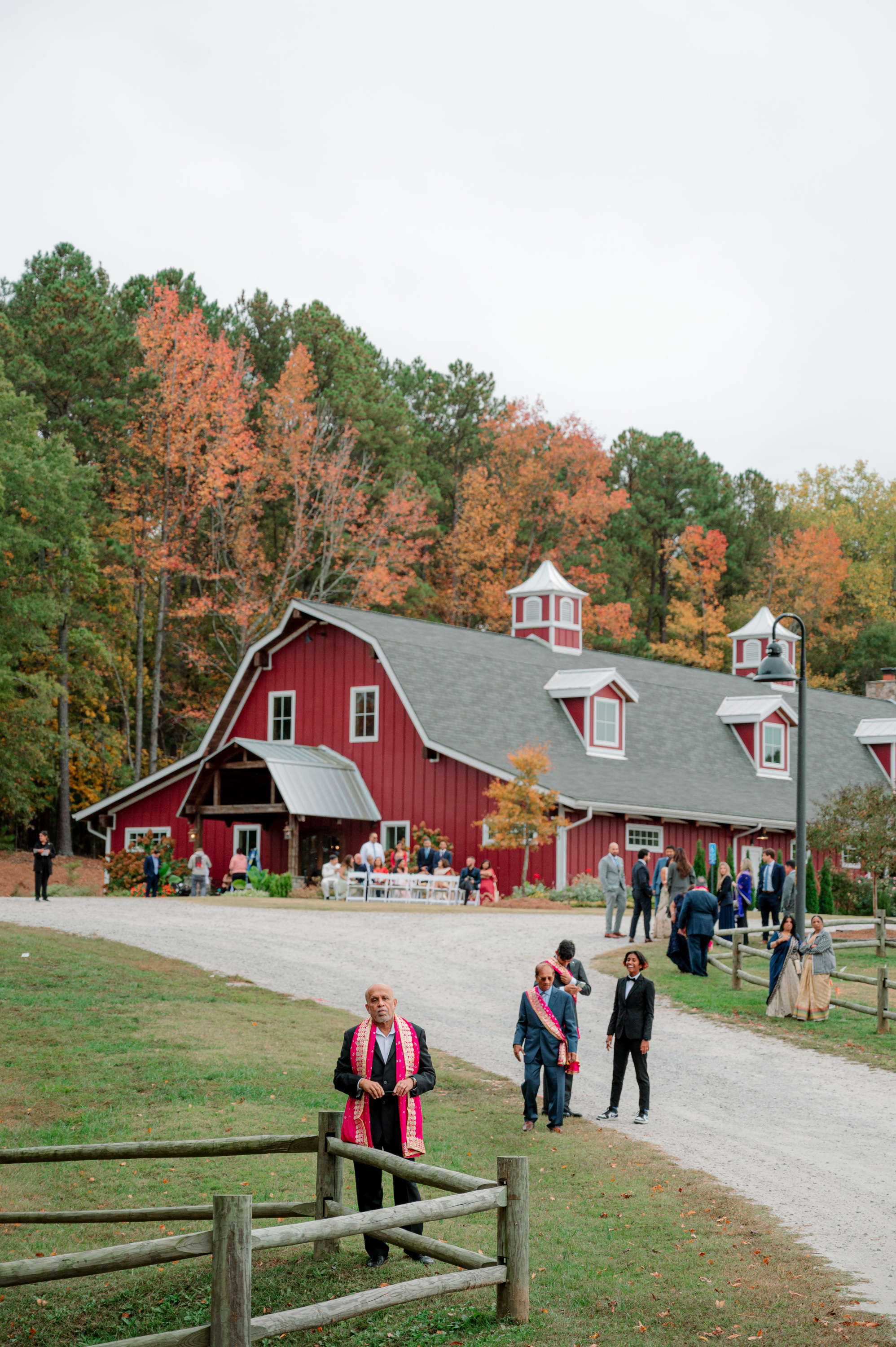 a group of people walking down a dirt road