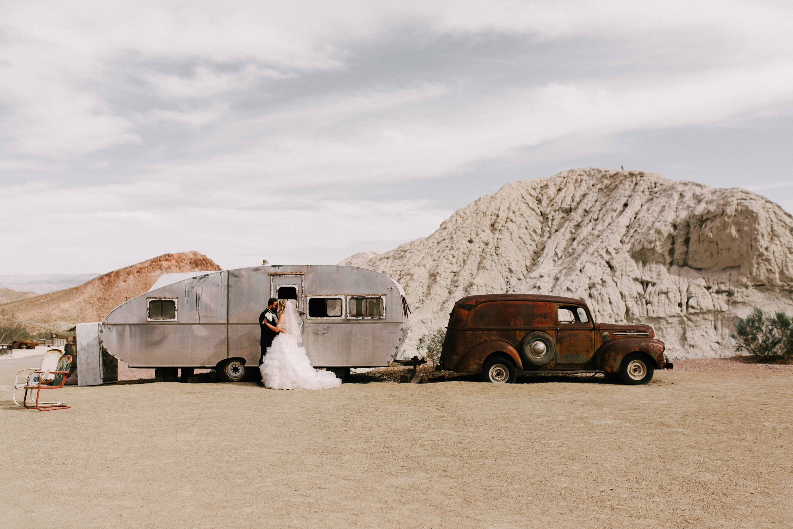 a couple standing next to a vintage truck