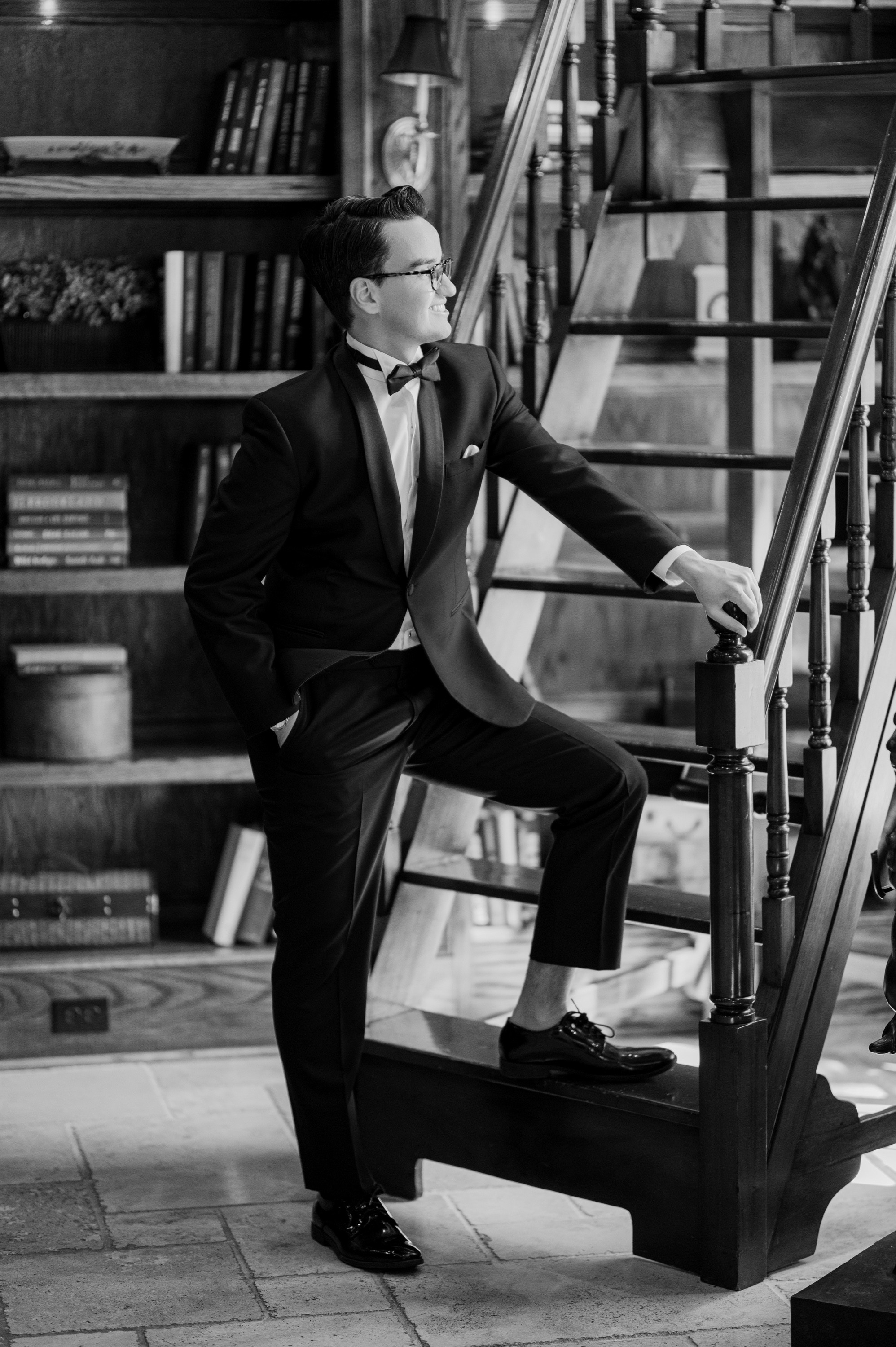 a man in a suit and tie is sitting on a stair