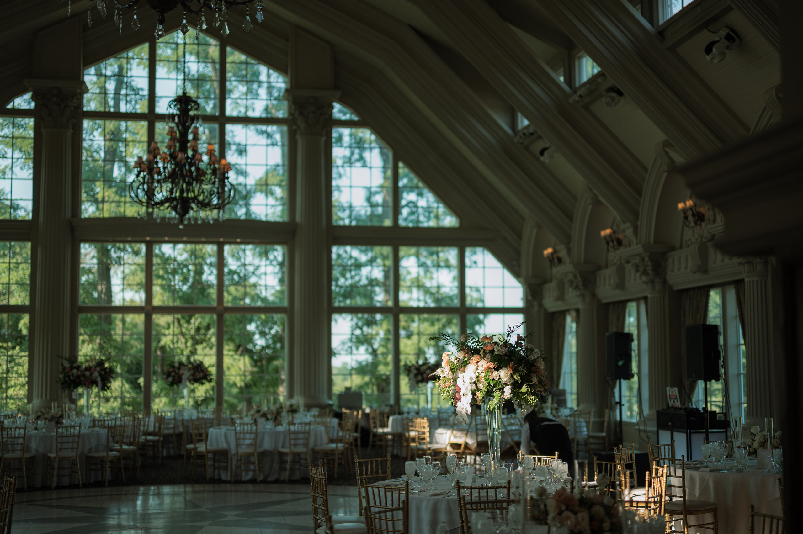 a large room with a large window and a chandel