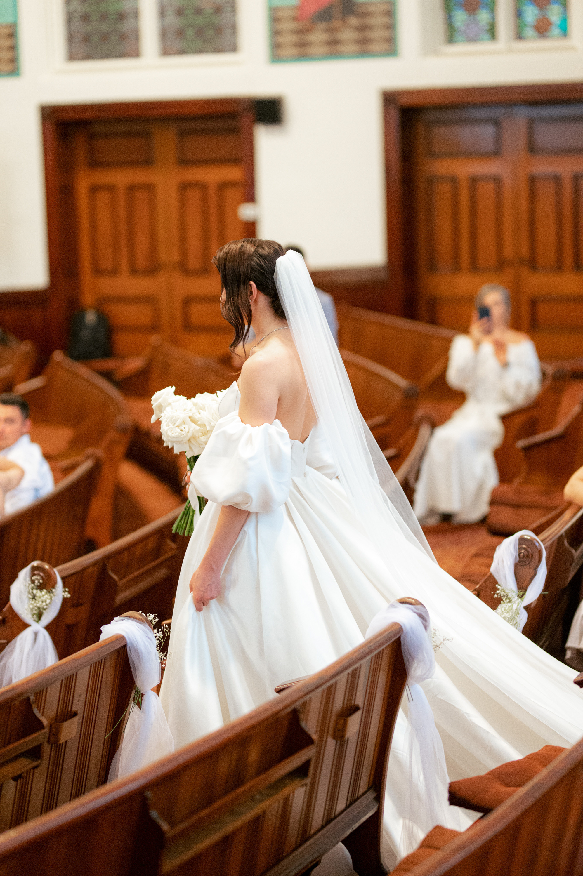 a bride walking down the aisle of a church