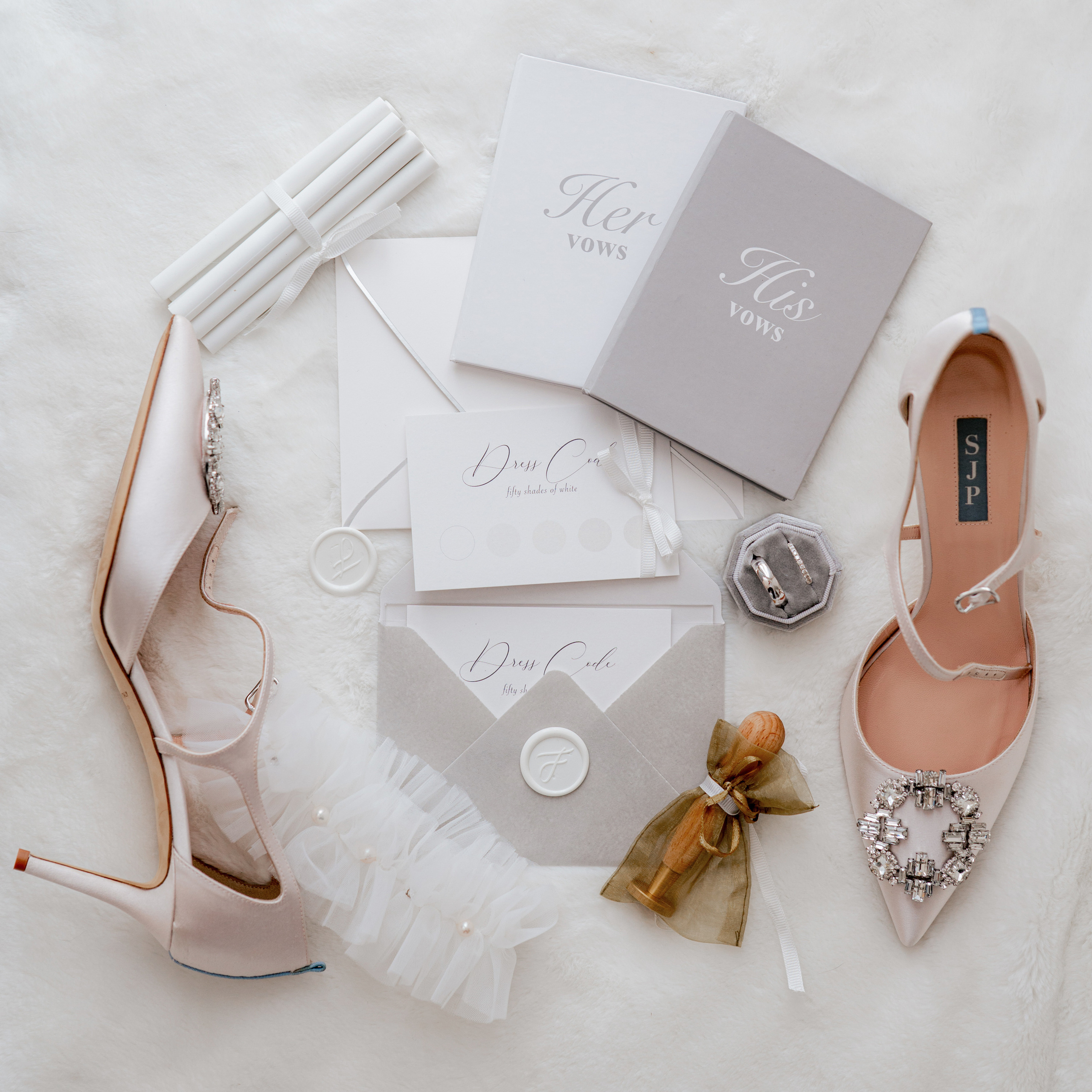 a white wedding dress and shoes on a white fur