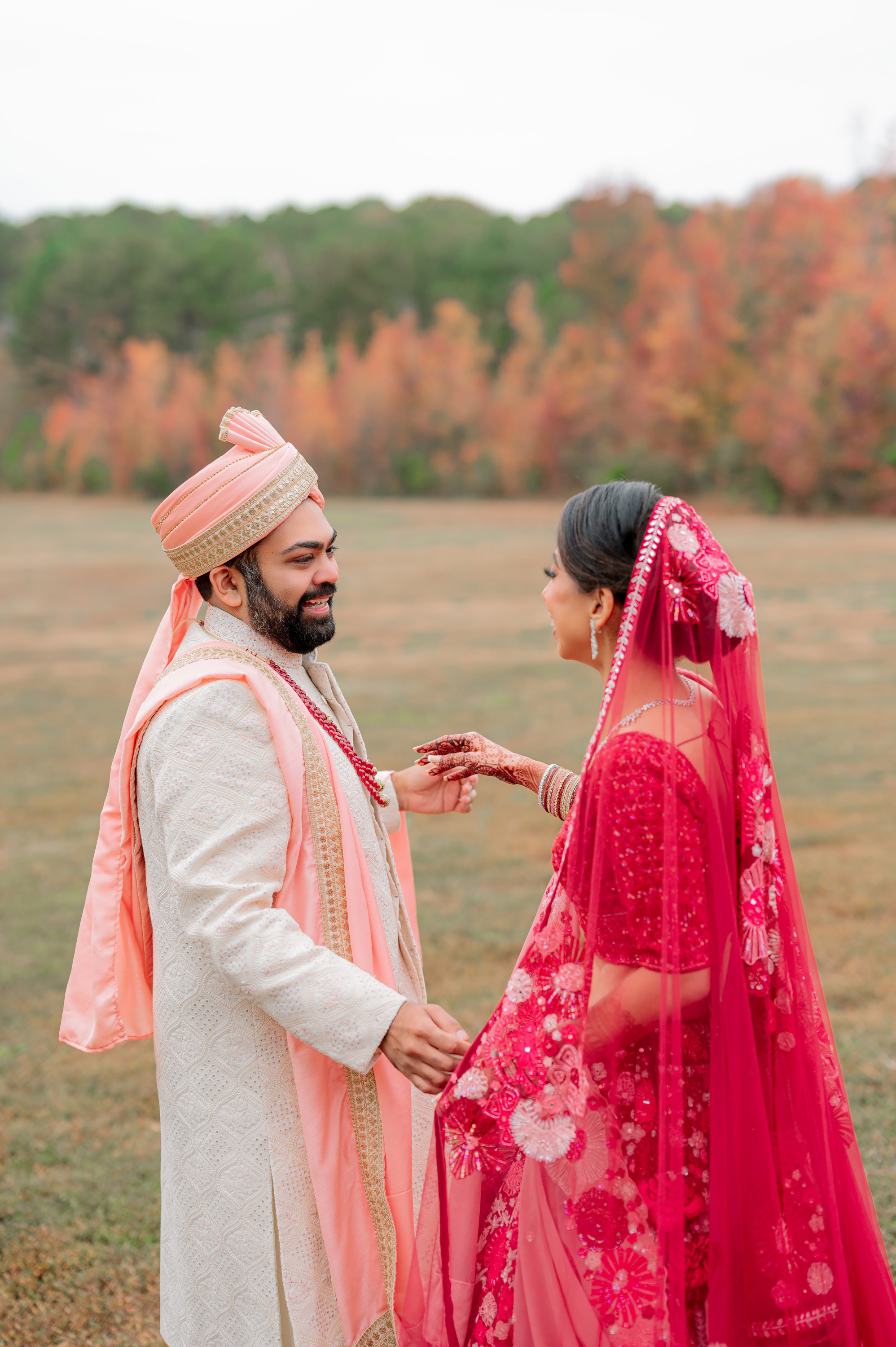 a man and woman in a pink dress and turbal