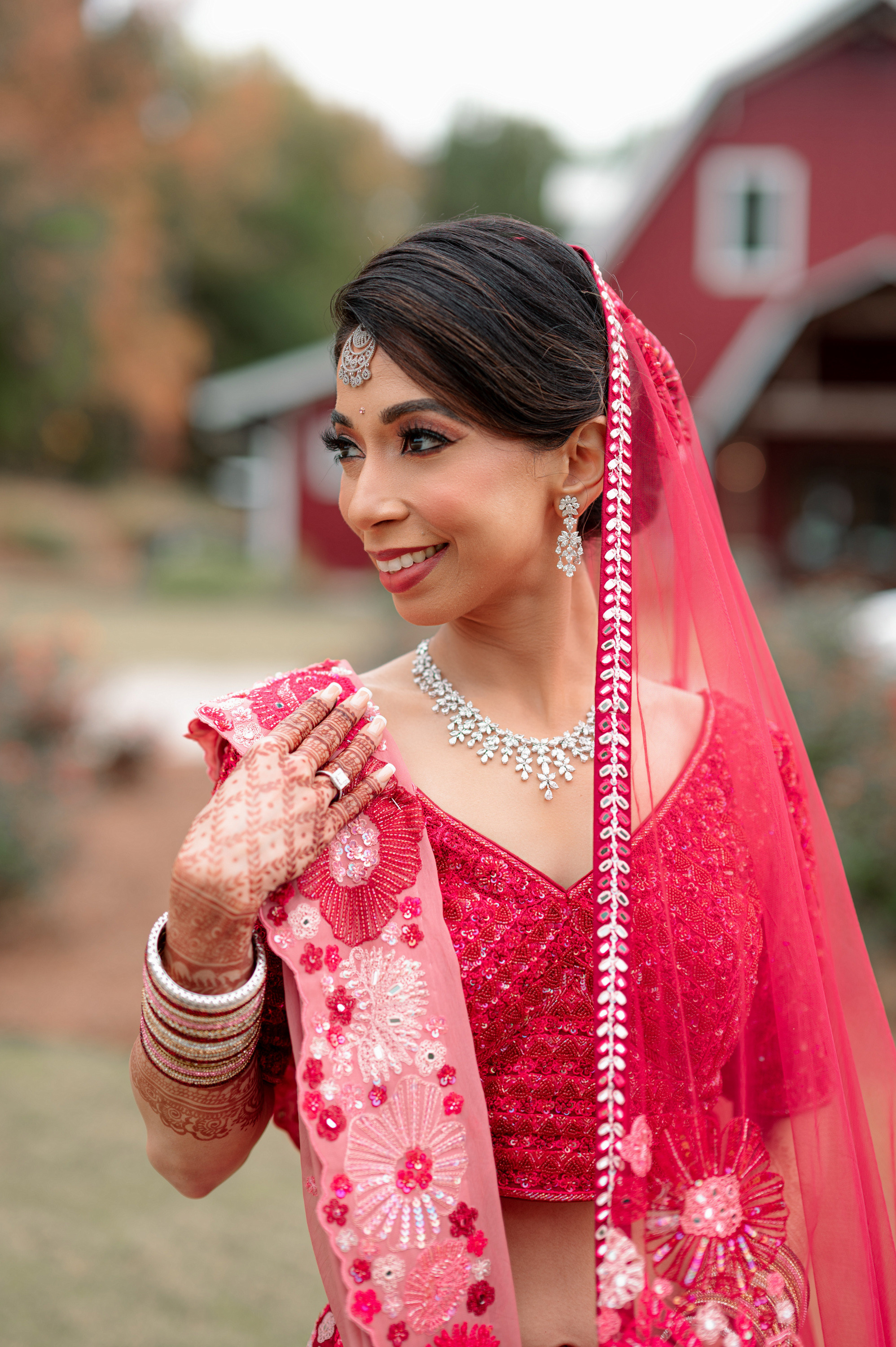 a woman in a red dress and a pink veil