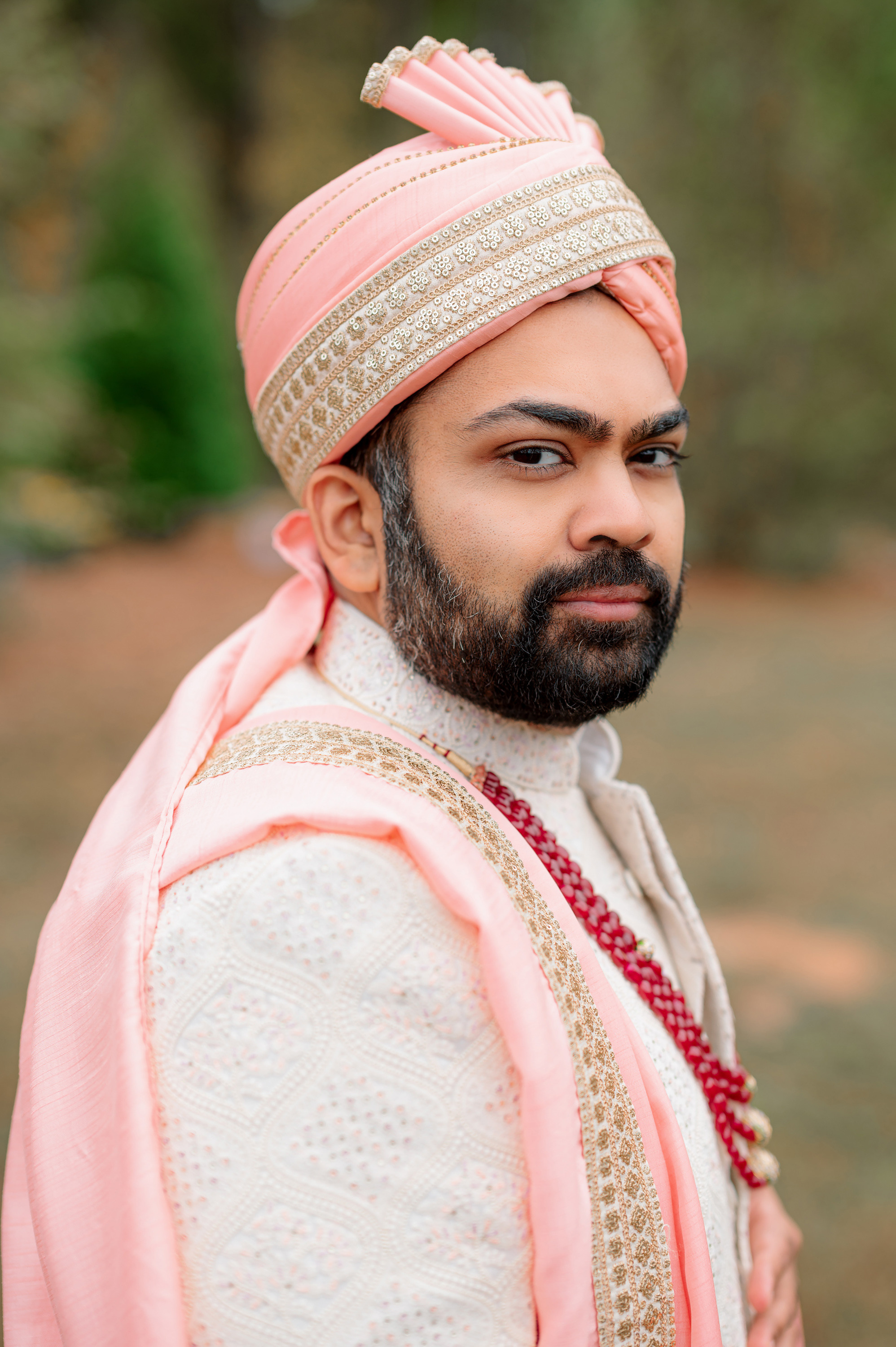 a man in a pink turbal and a pink turbal