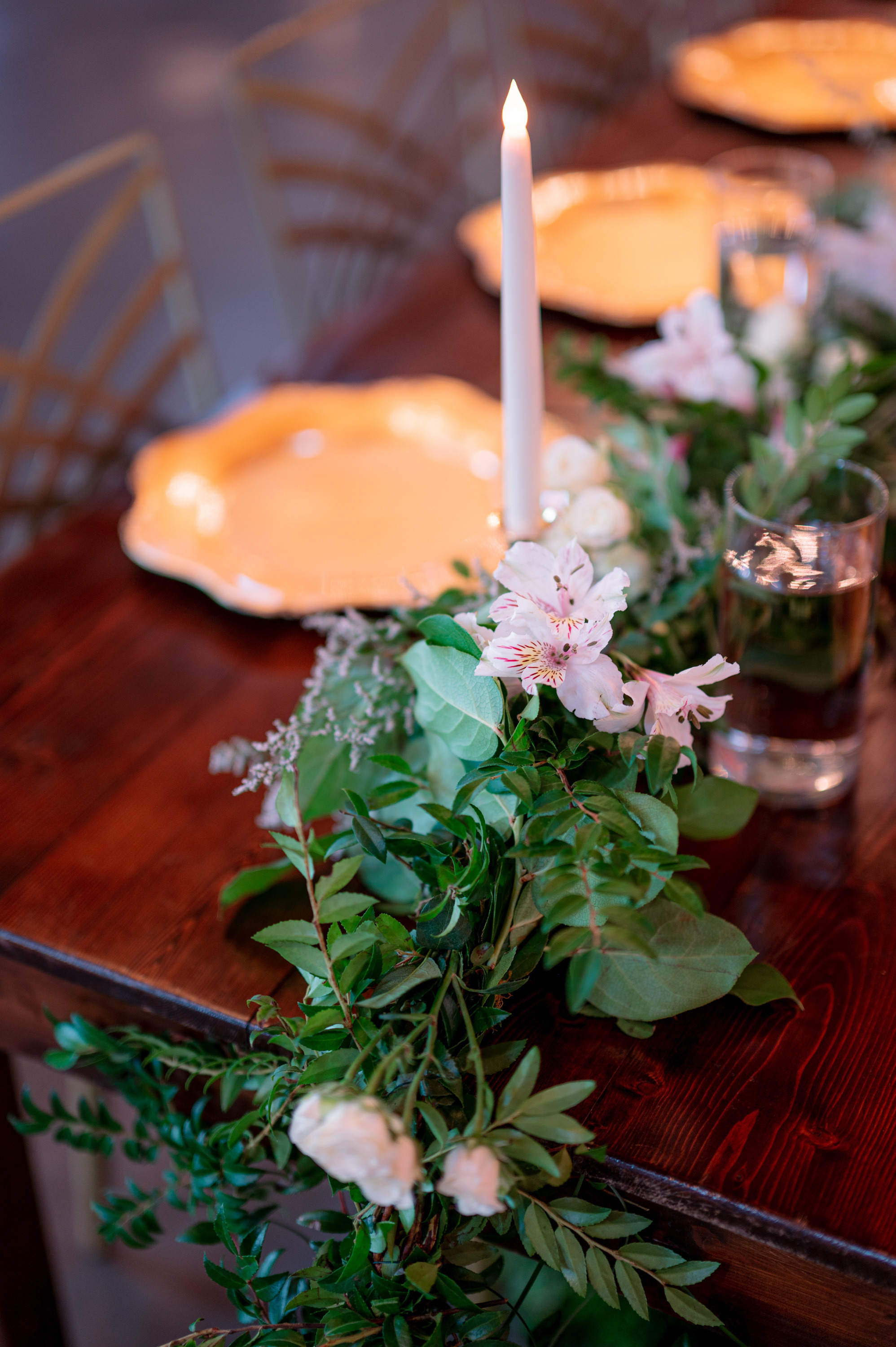 a table with a candle and flowers on it
