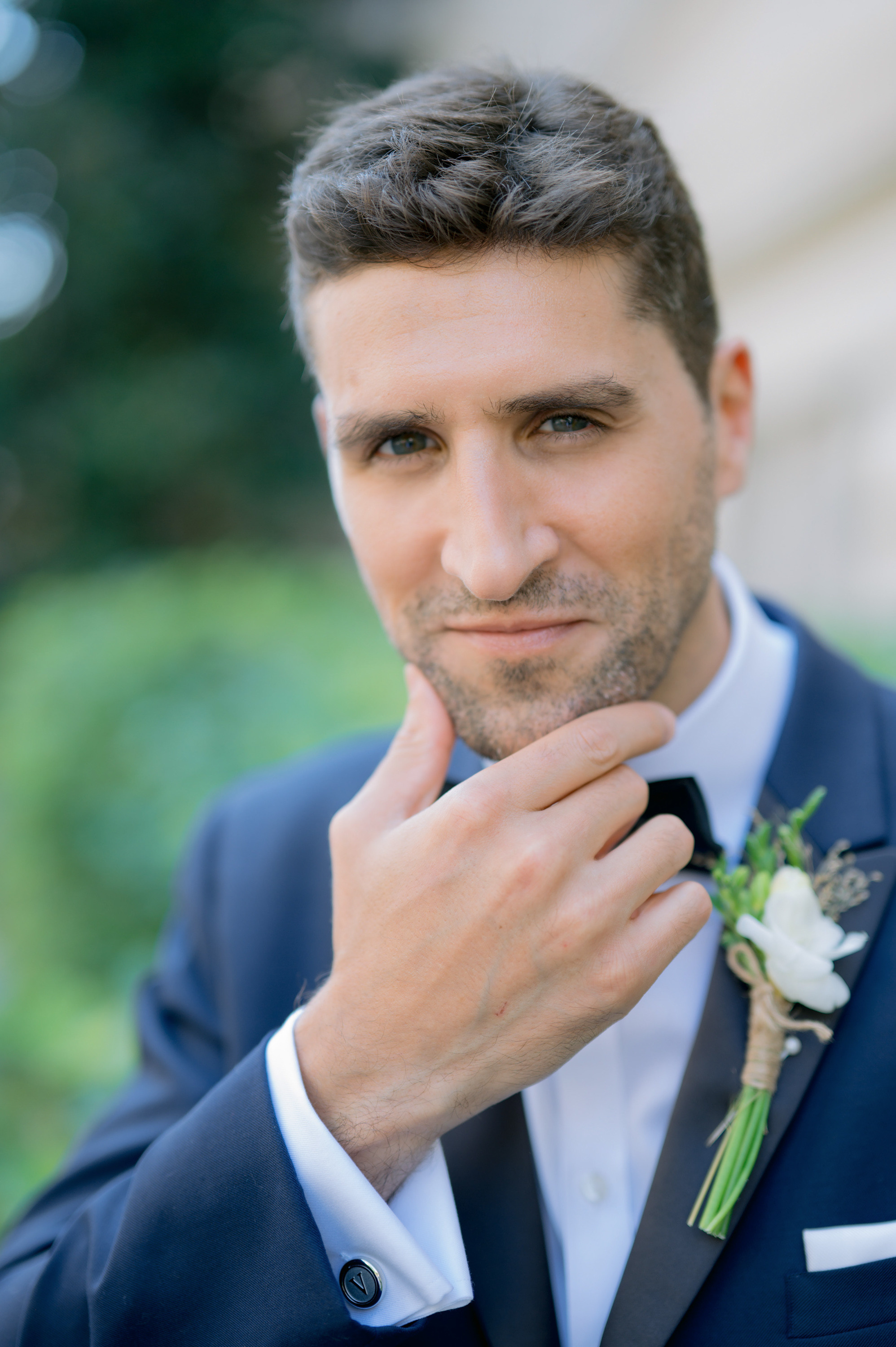 a man in a suit and tie with a flower