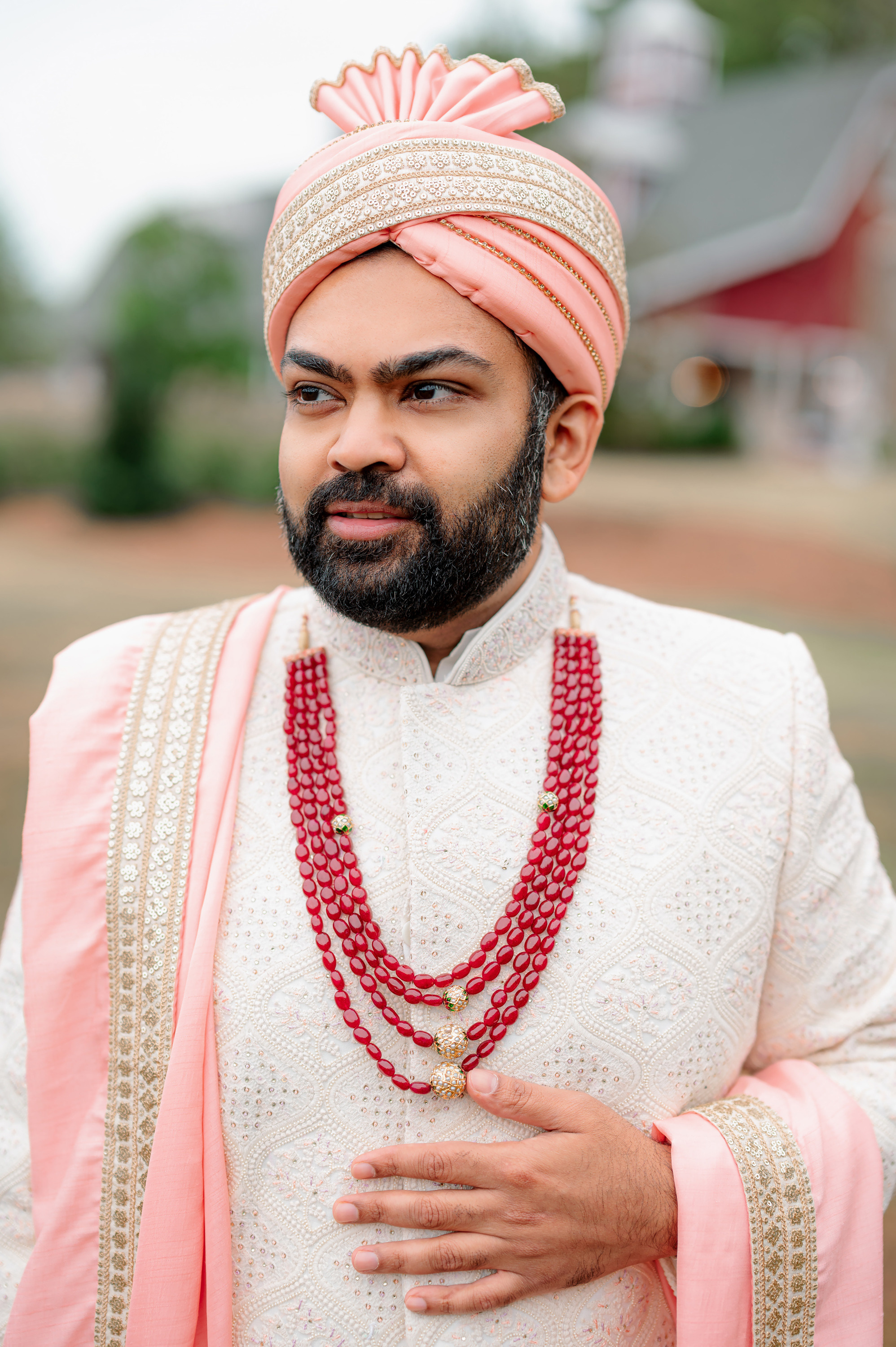 a man in a pink turba and a pink turbal