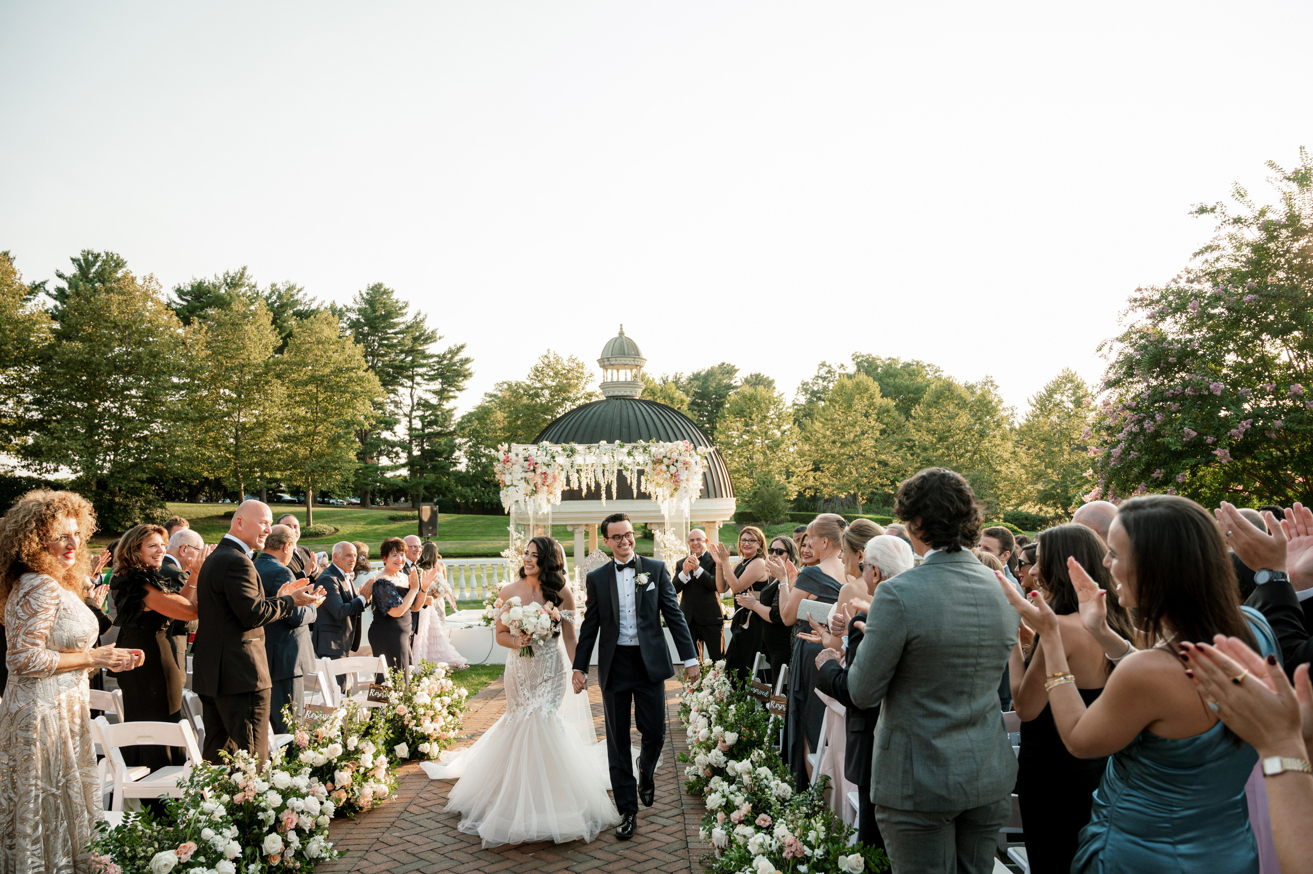 a bride and groom walking down the aisle