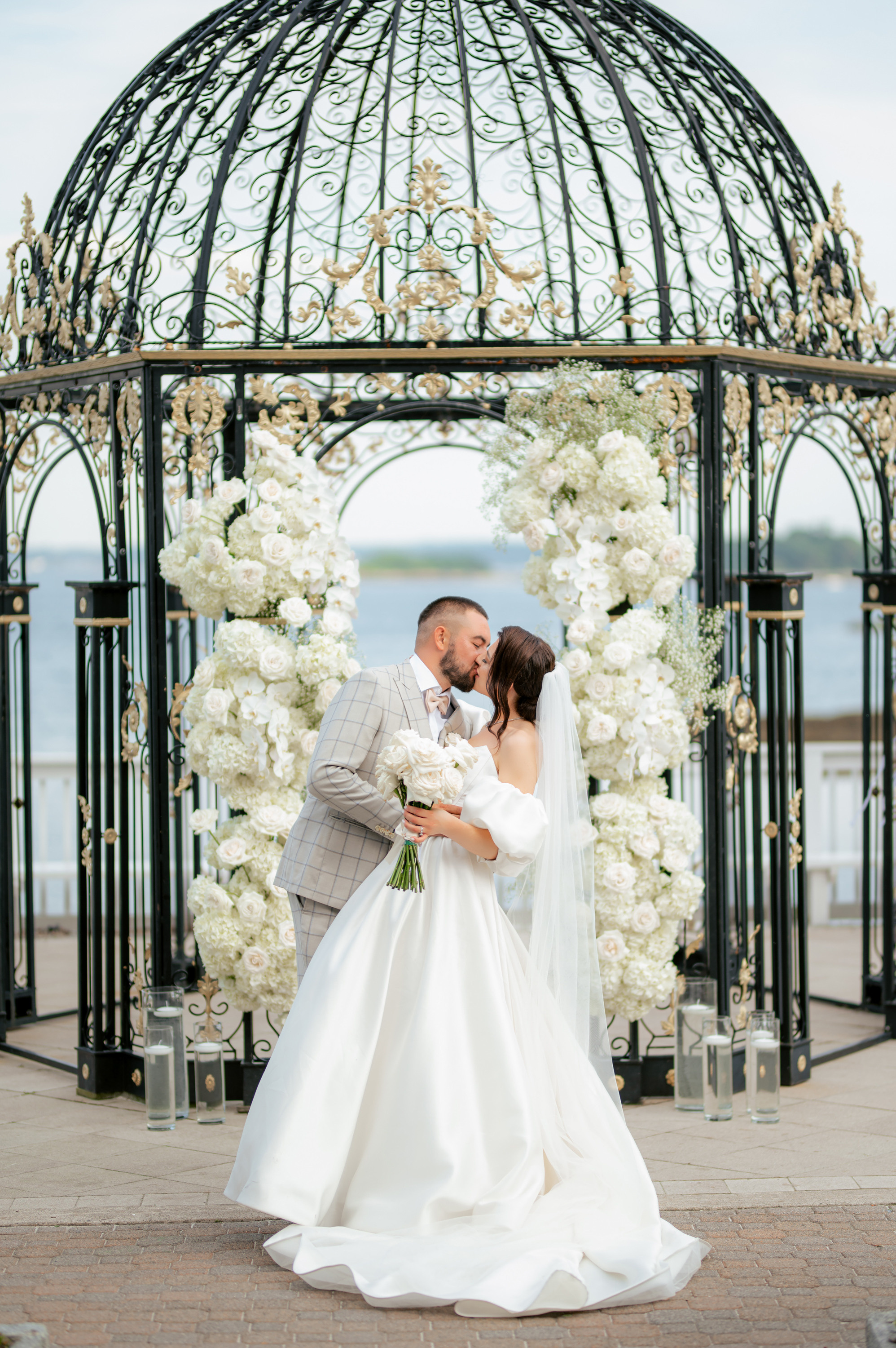 a bride and groom kissing under a gaze at their wedding