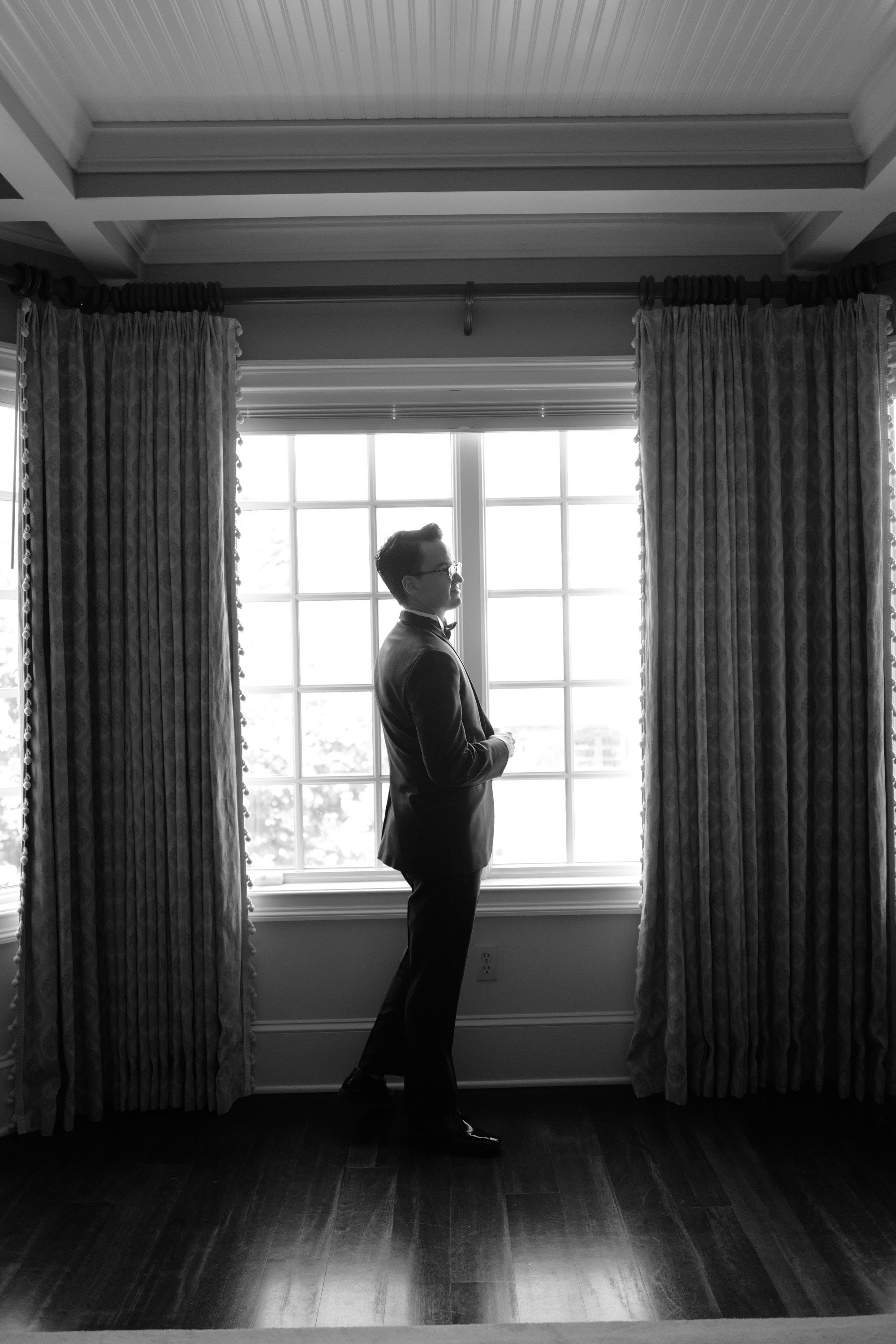 a man standing in front of a window