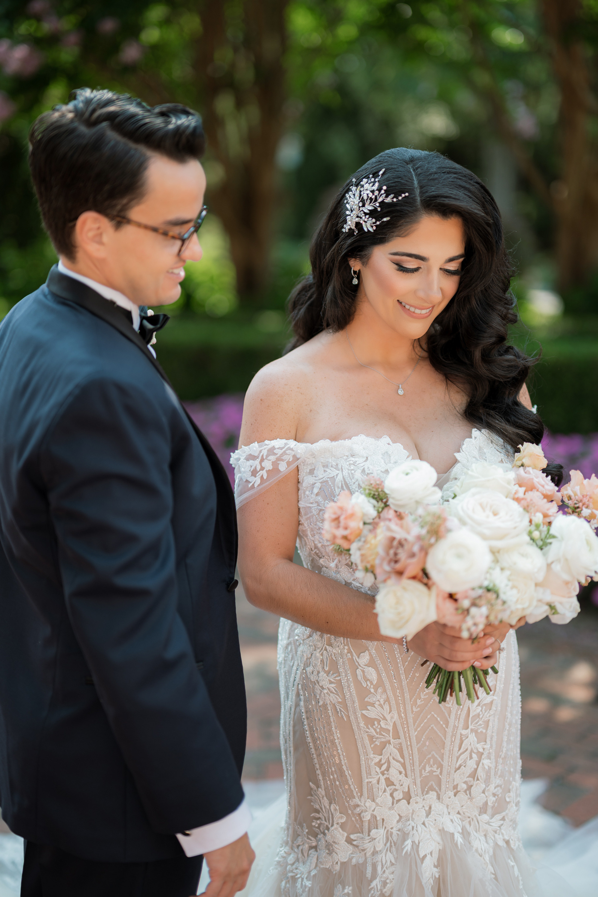 a bride and groom standing in front of a tree