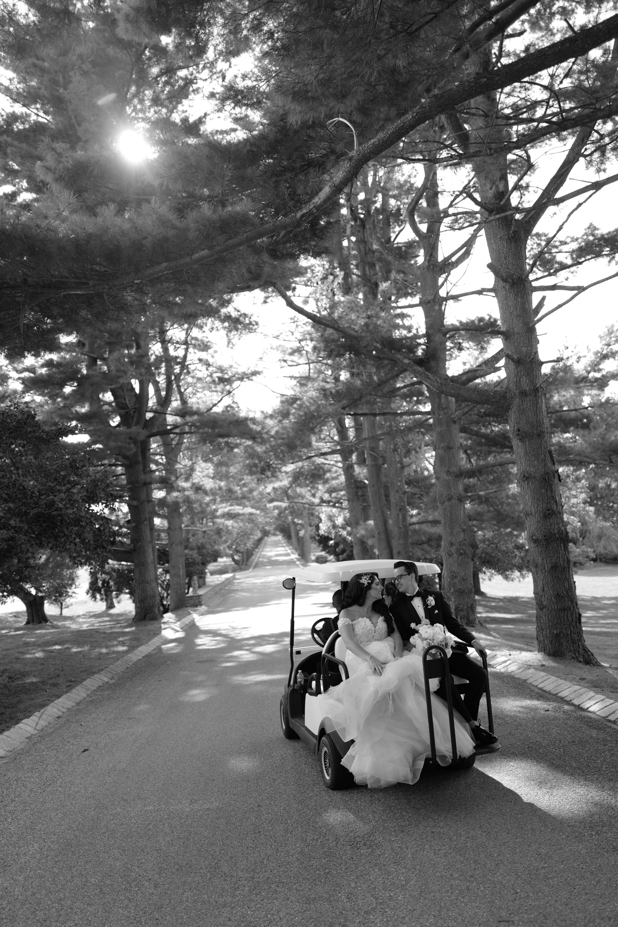 a bride and groom are sitting in a golf cart