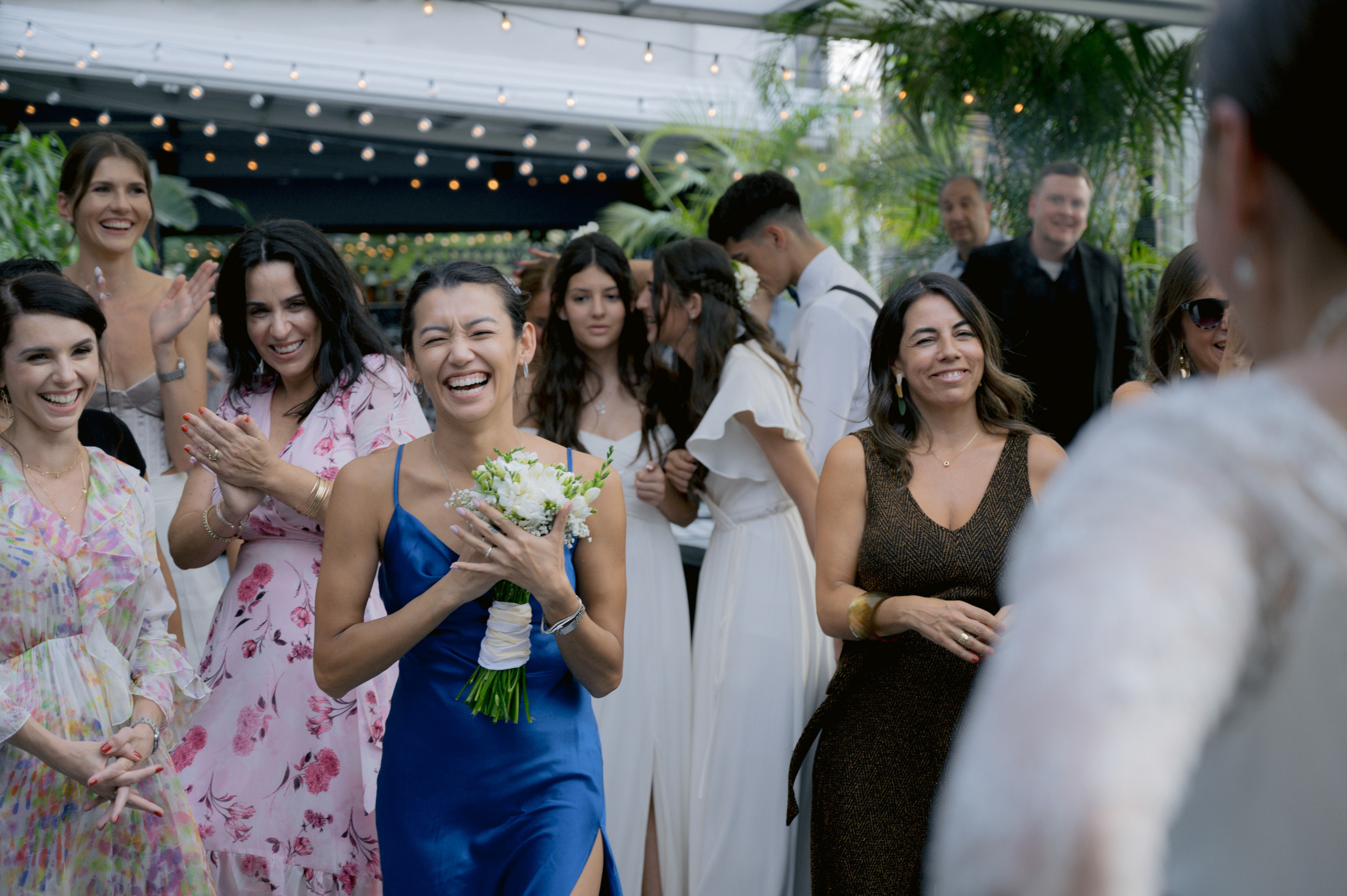 a group of women standing around a man