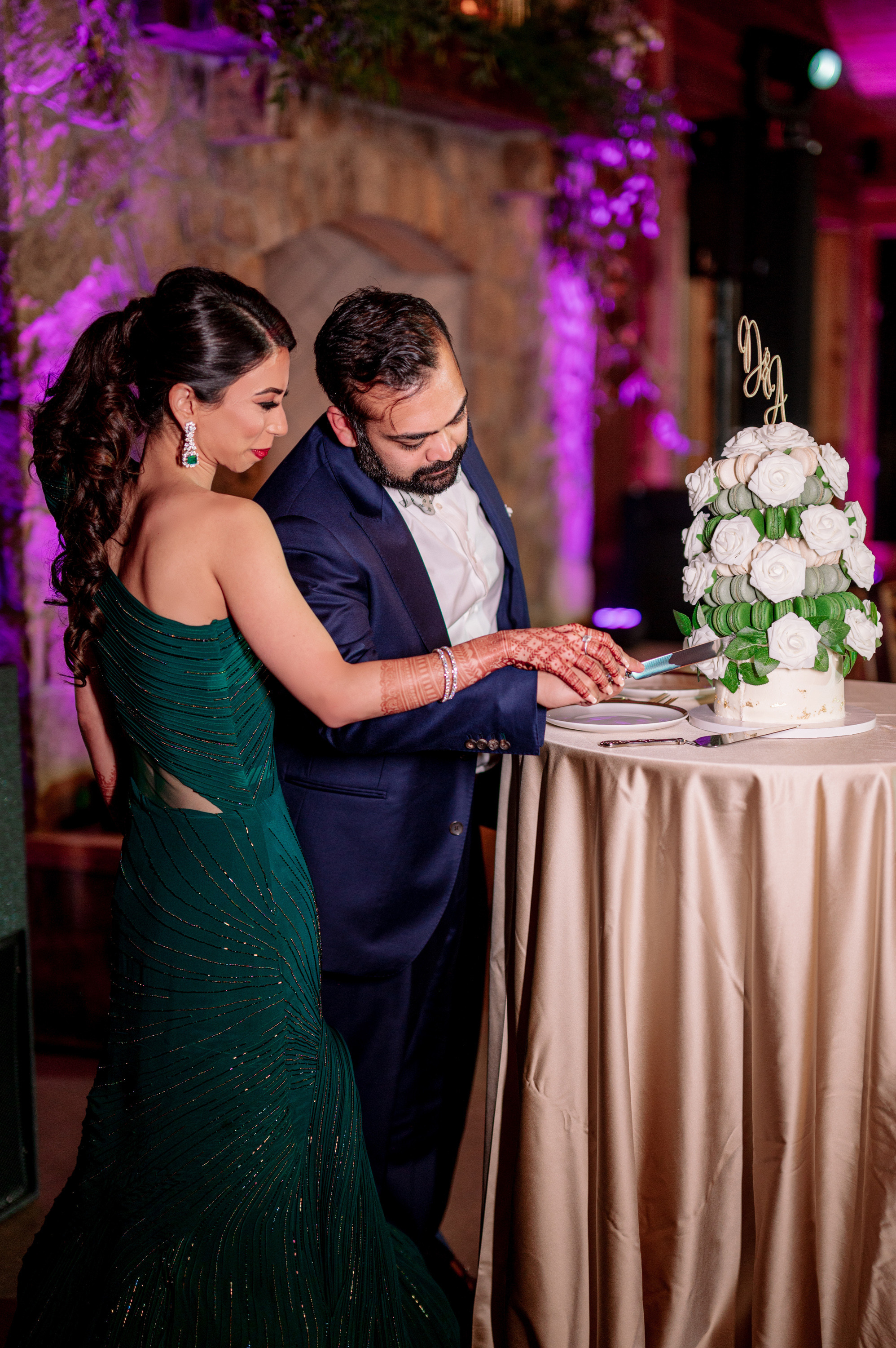 a man and woman cutting a cake together