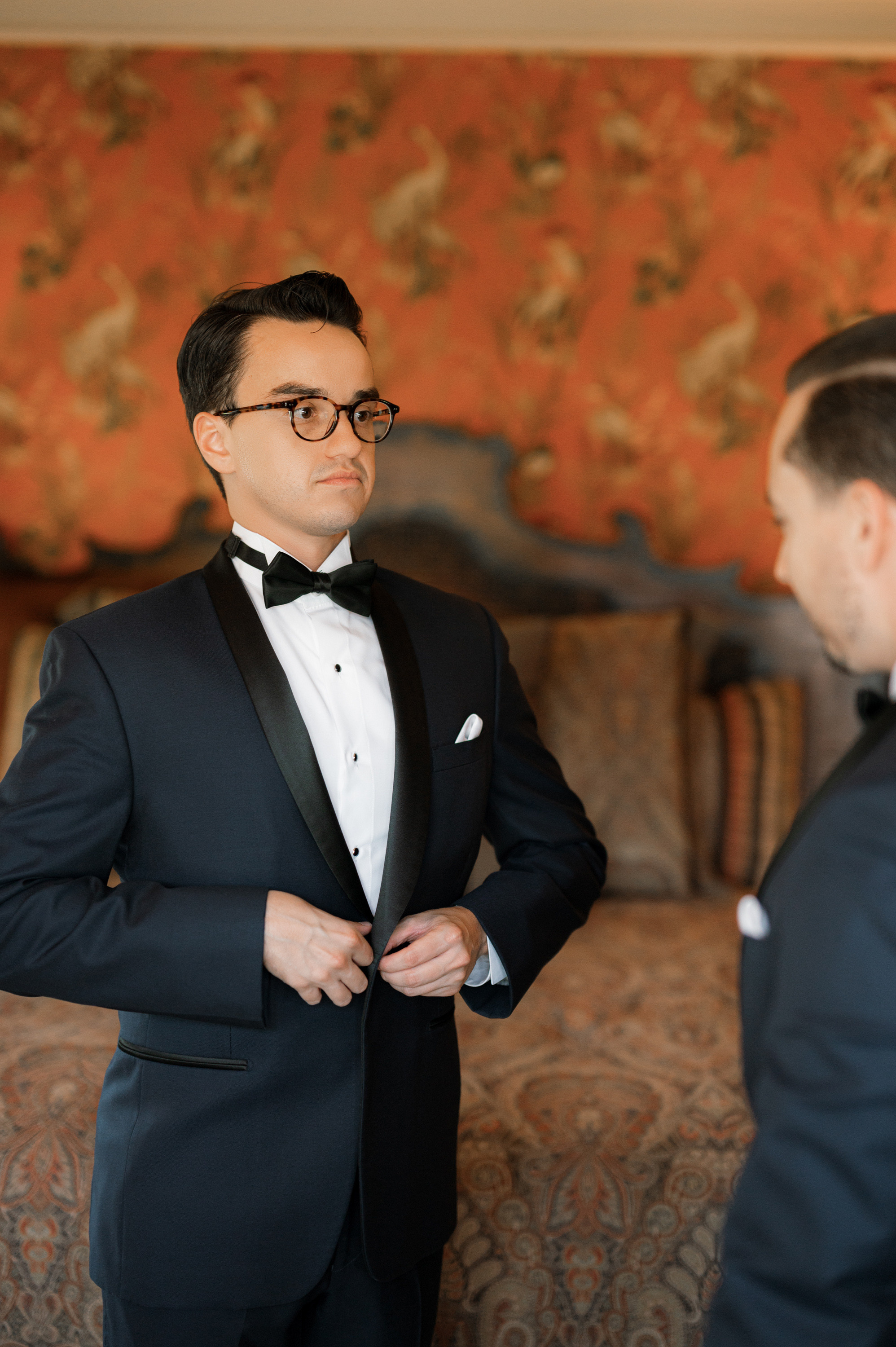 a man in a tuxed suit and bow tie