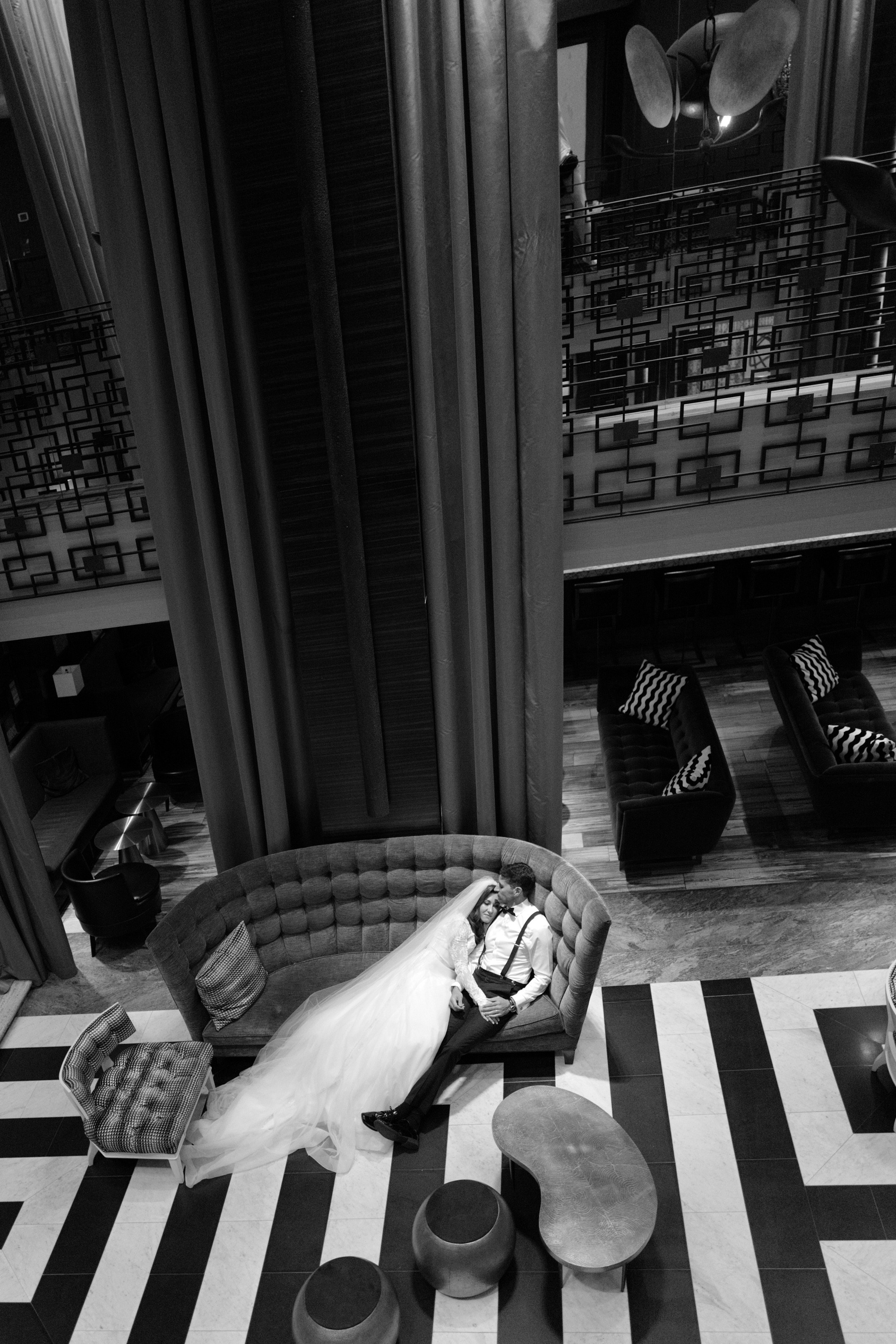 a black and white photo of a woman sitting on a couch