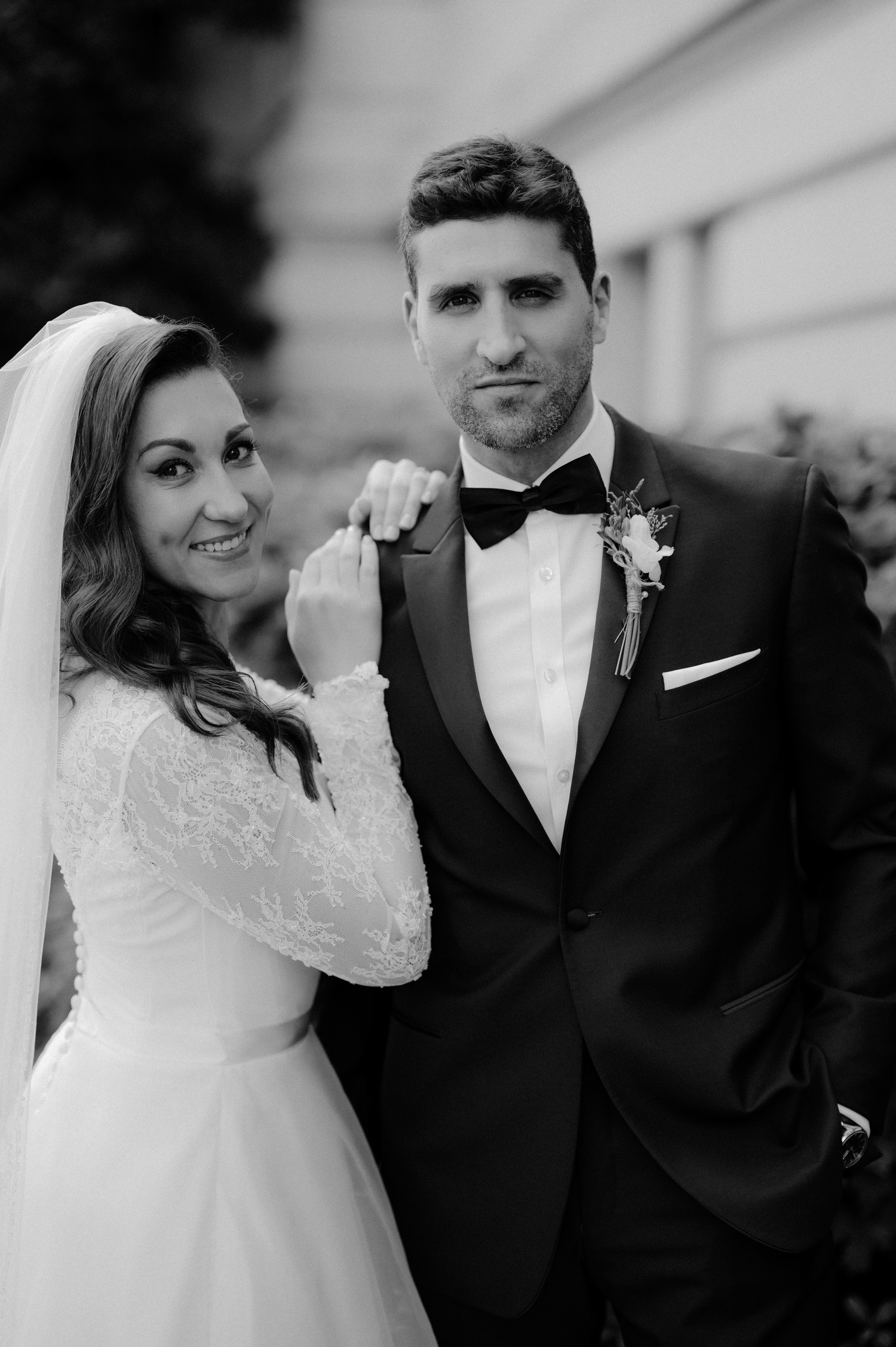 a bride and groom pose for a photo