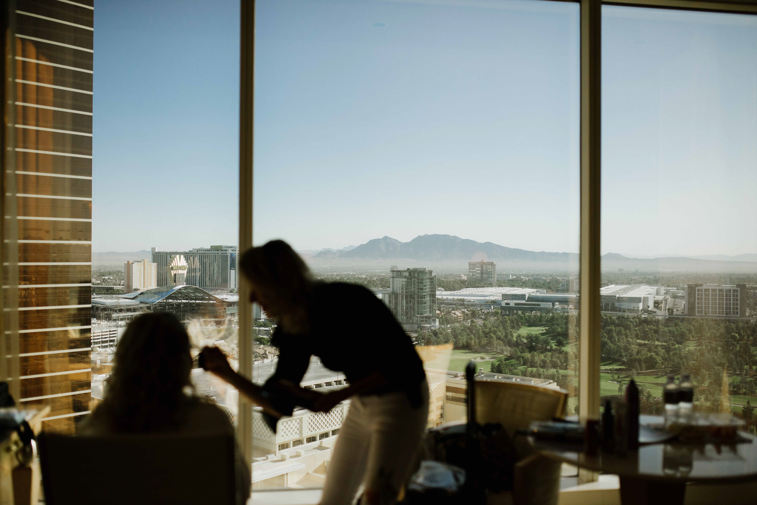 a couple sitting at a table in front of a window