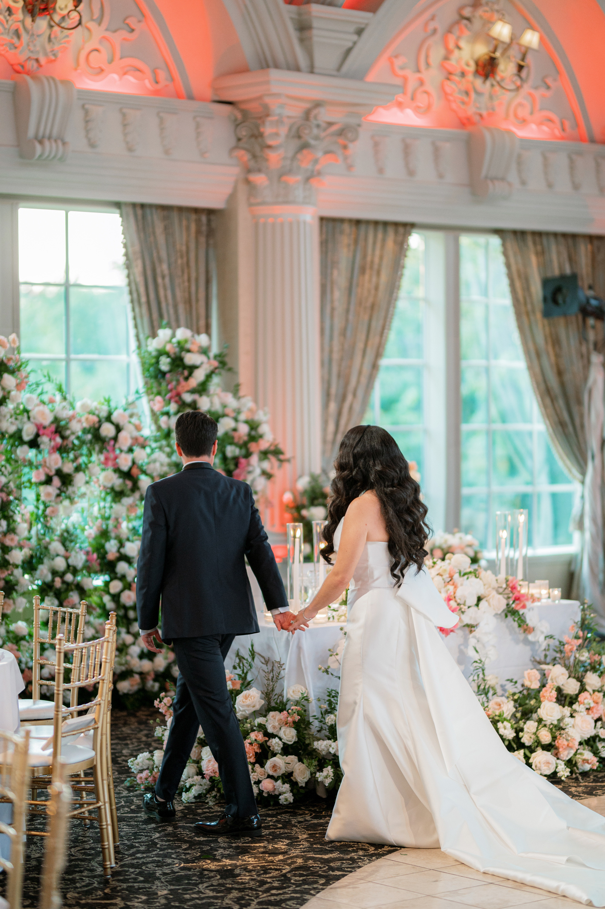 a bride and groom are walking down the aisle