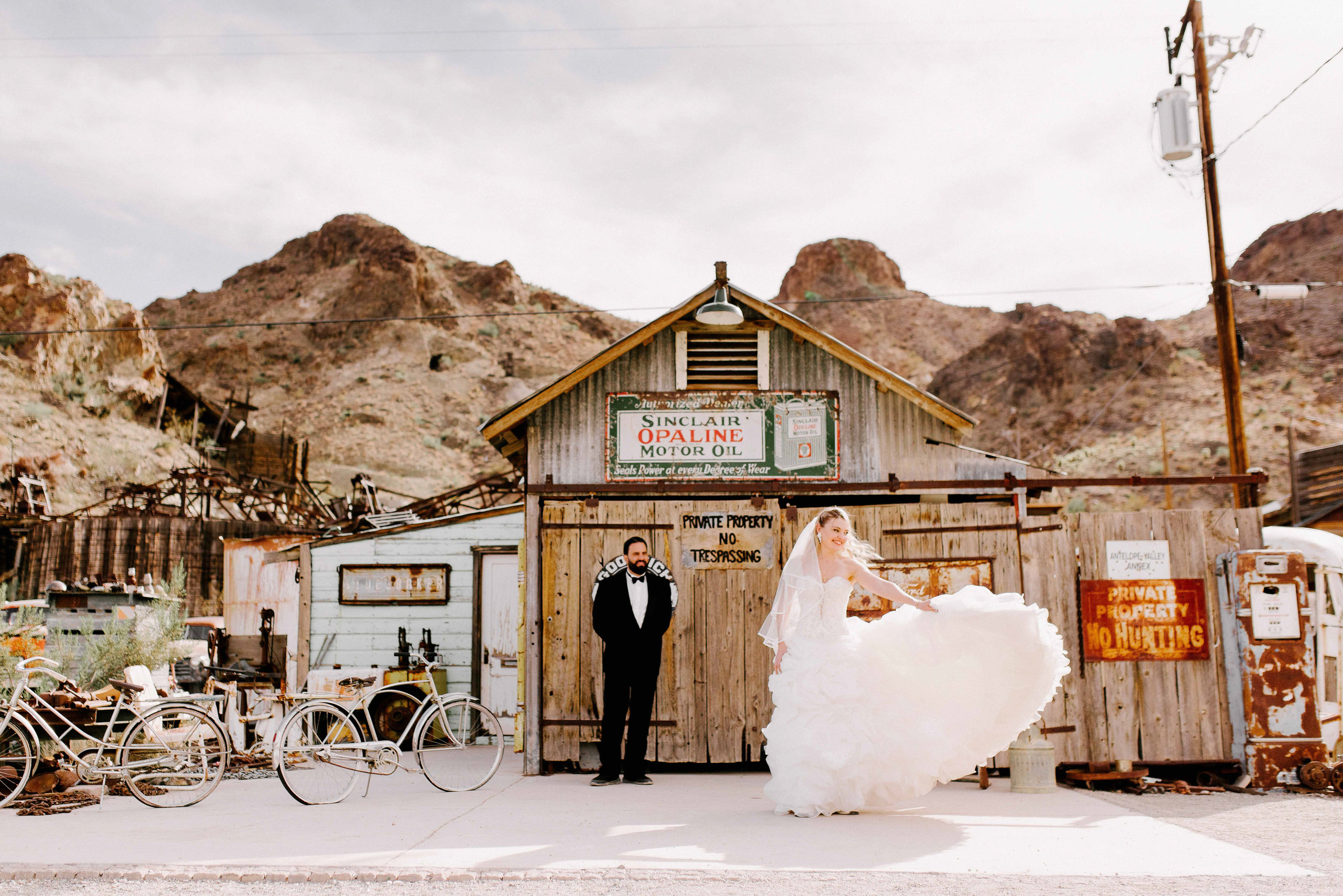 a bride and groom are standing in front of a building