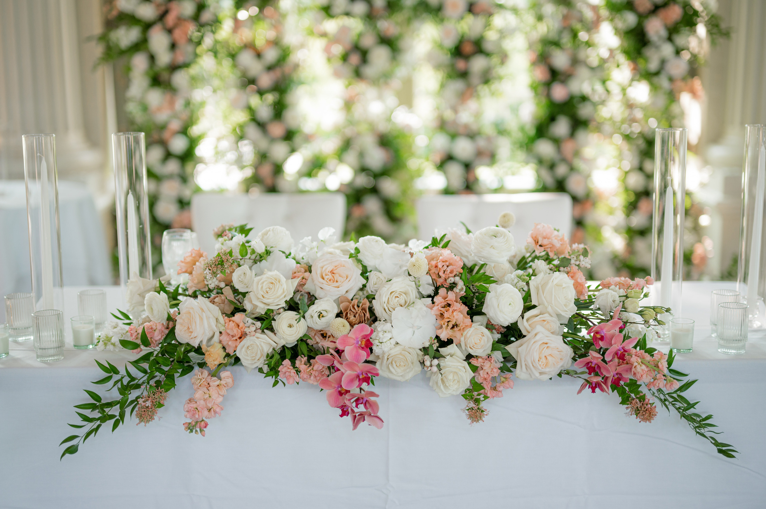 a table with flowers and candles on it