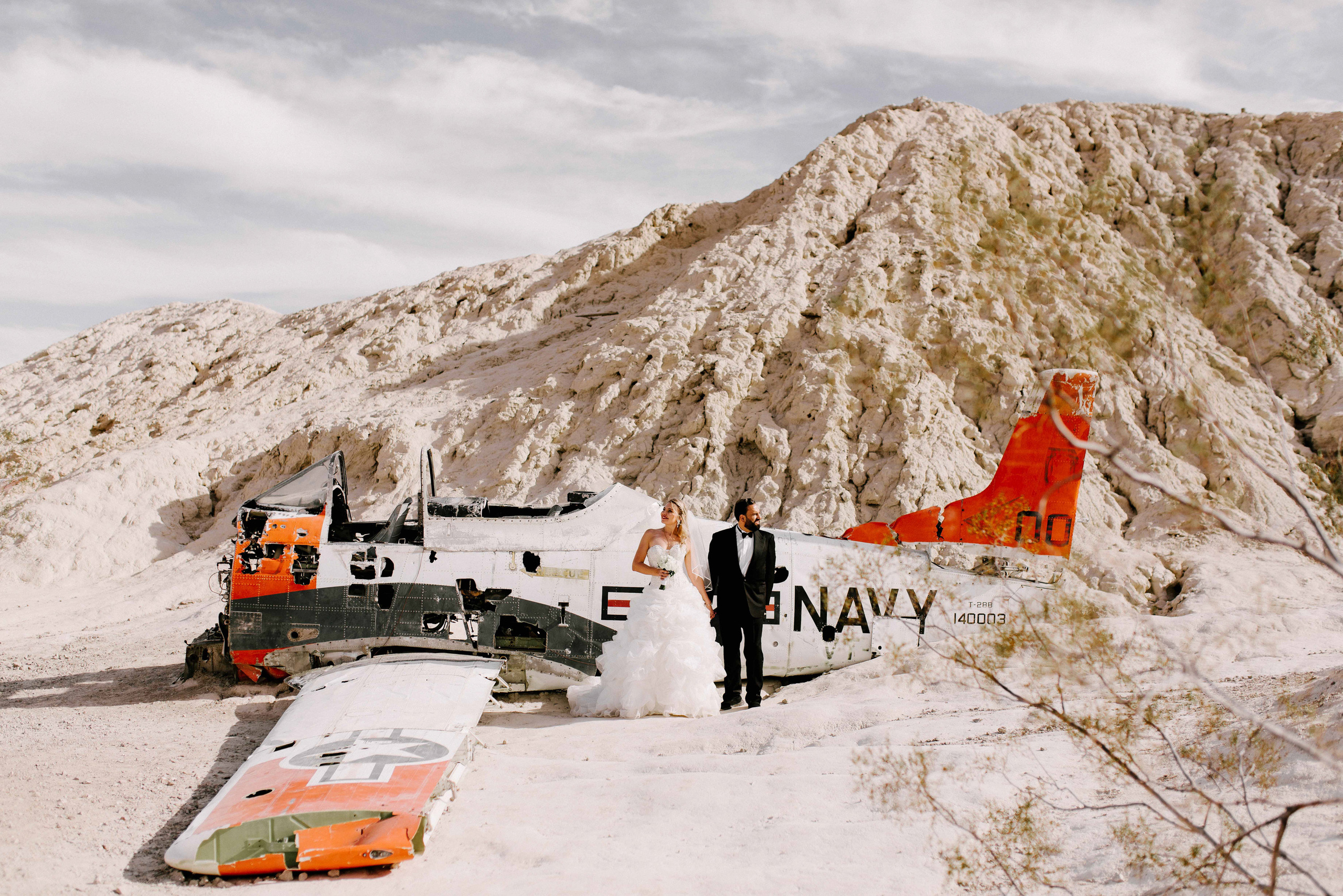 a man standing next to a plane in the snow