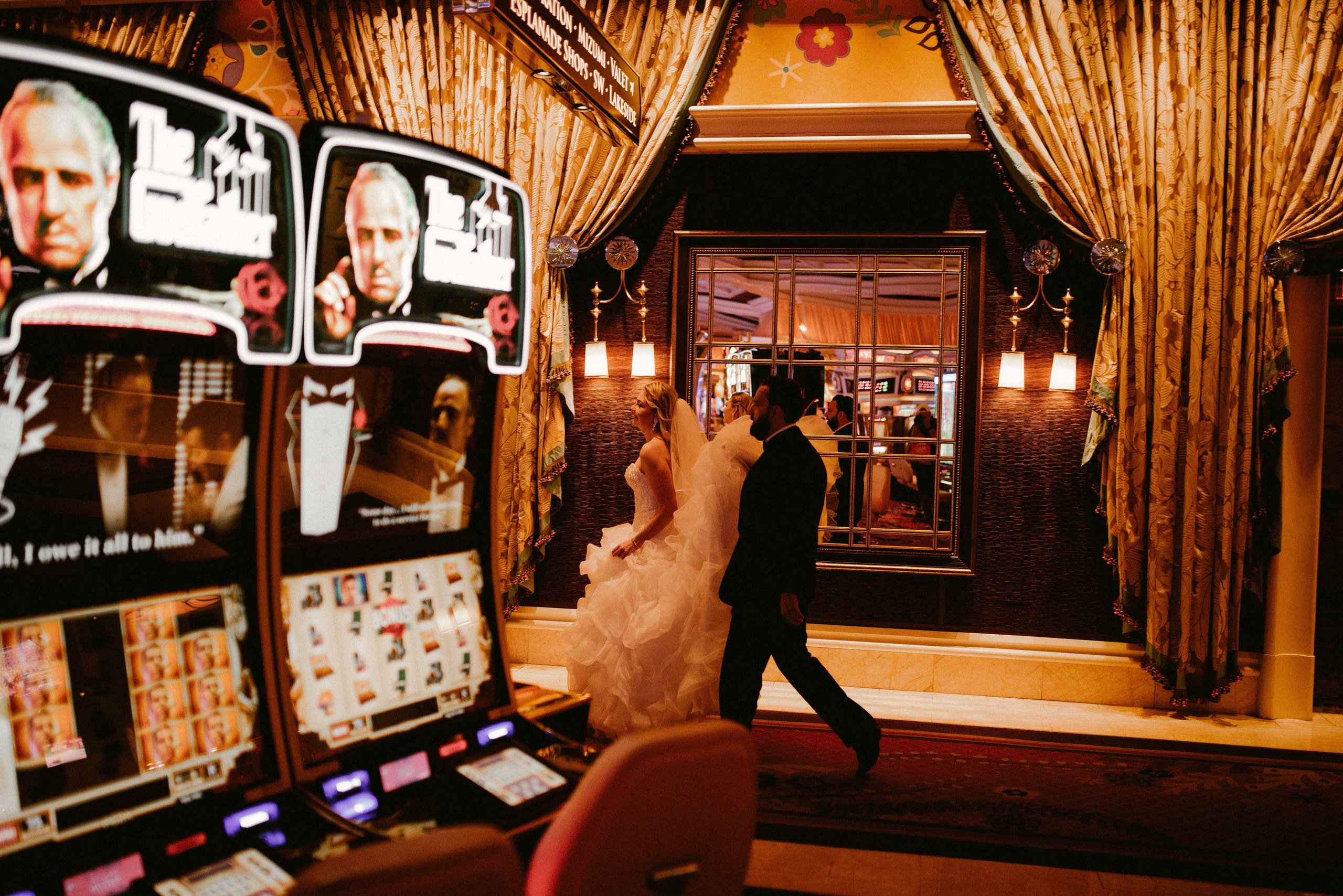 a bride and groom walking through a hotel lobby