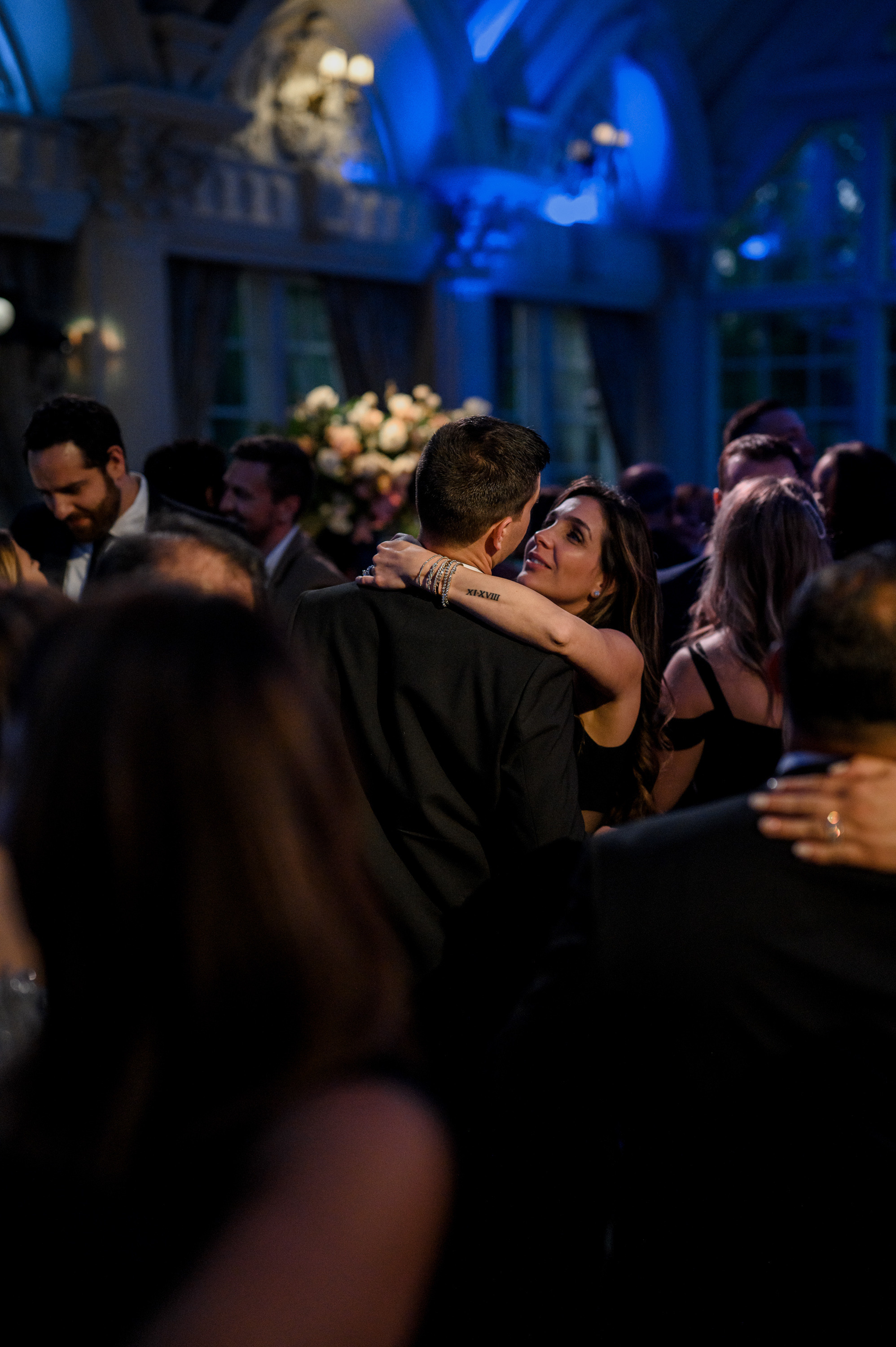 a couple is hugging each other people