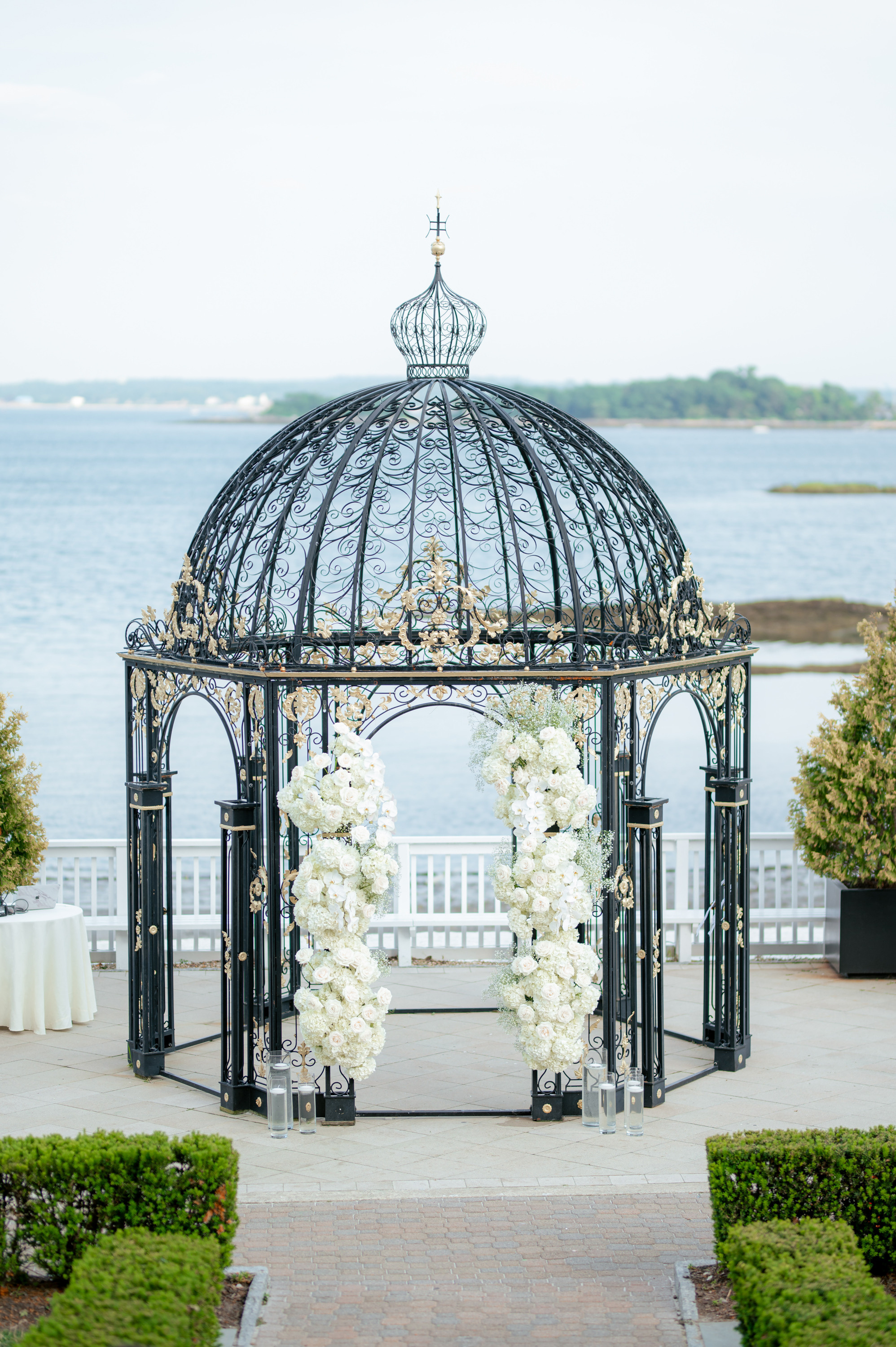 a gaze with flowers and a white rose arrangement