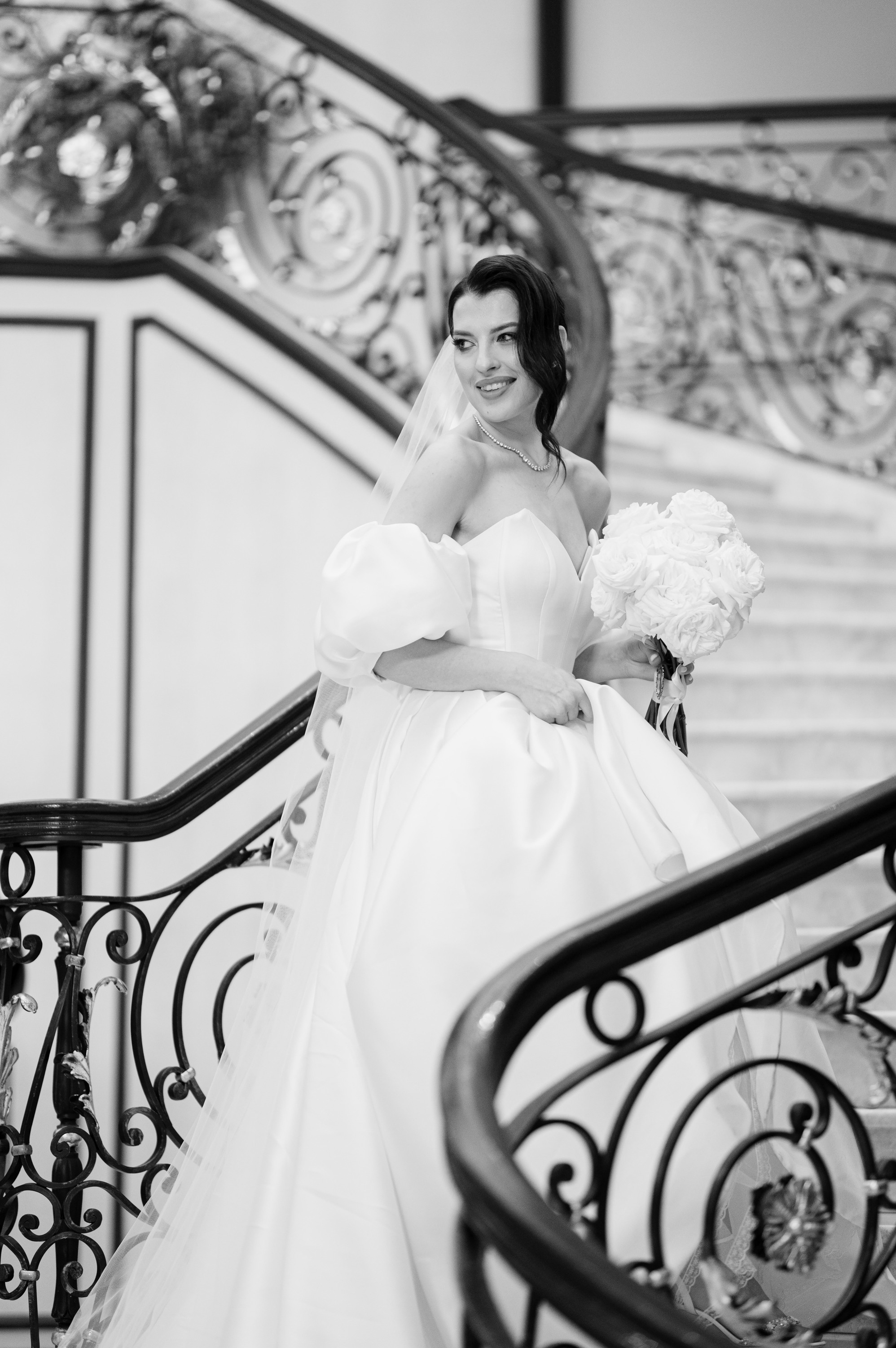 a bride walking down the stairs at the top of the stairs