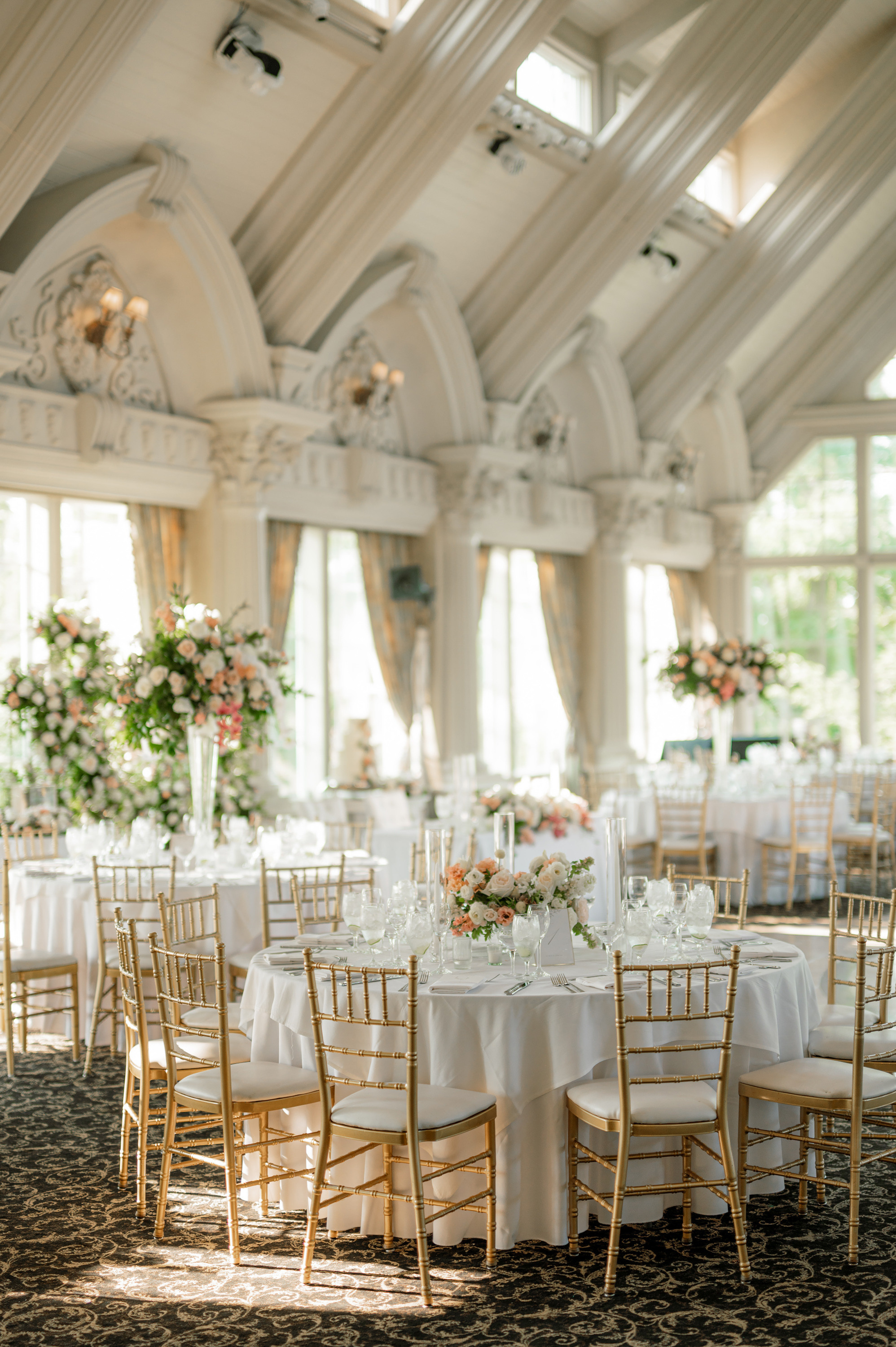 a room with tables and chairs and a chandel
