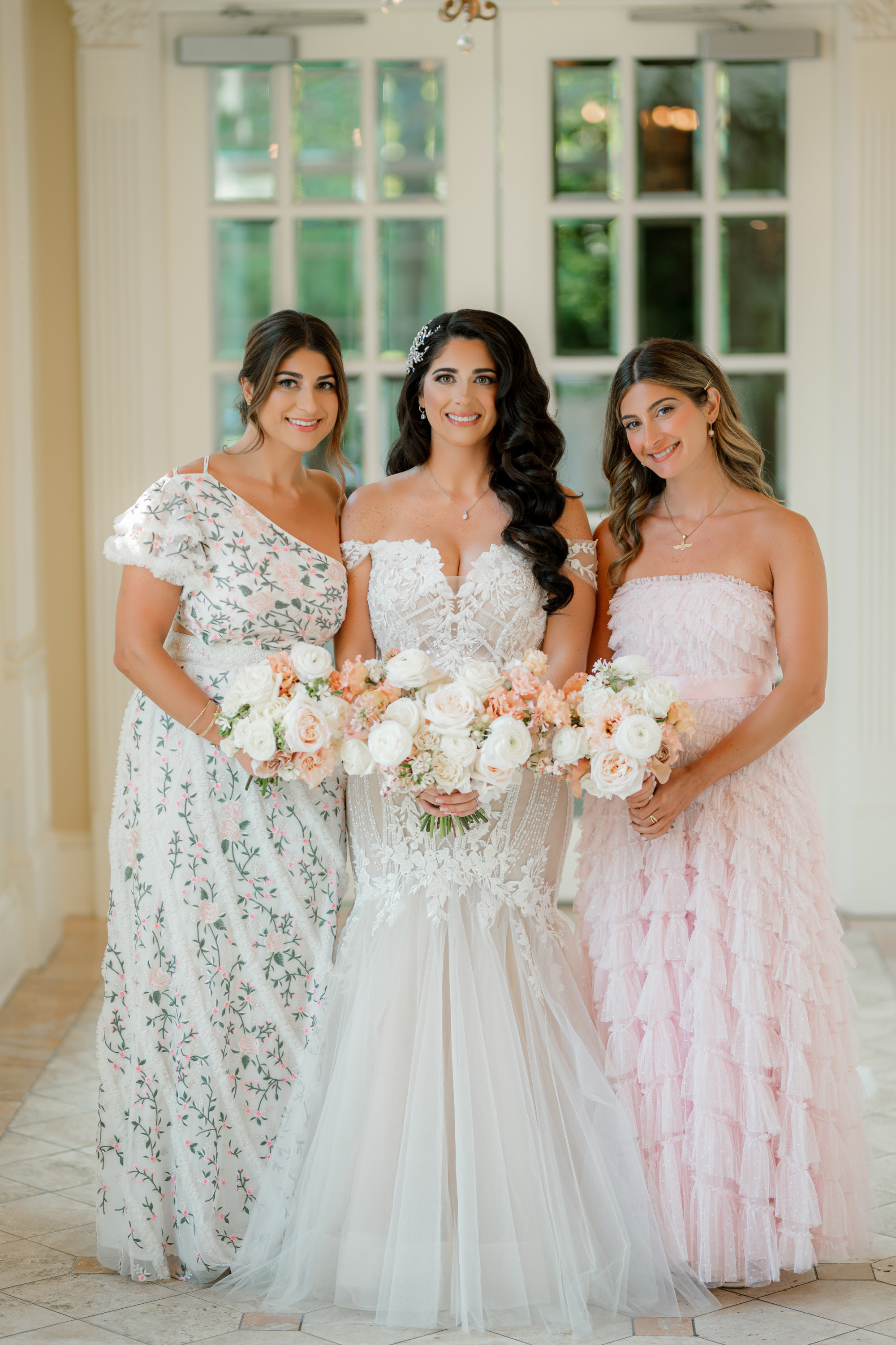 three brides in dresses standing together