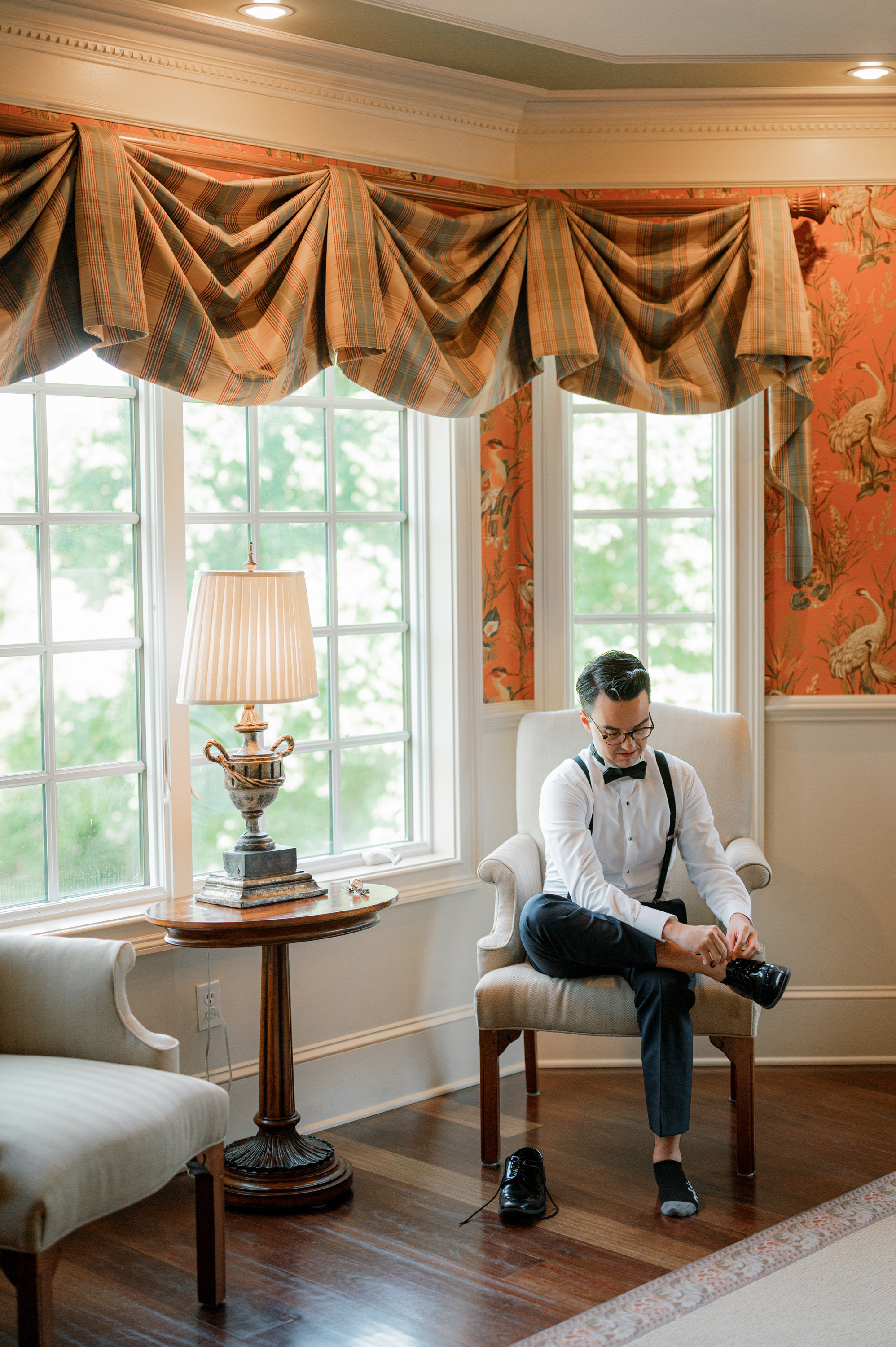 a man sitting in a chair in a living room