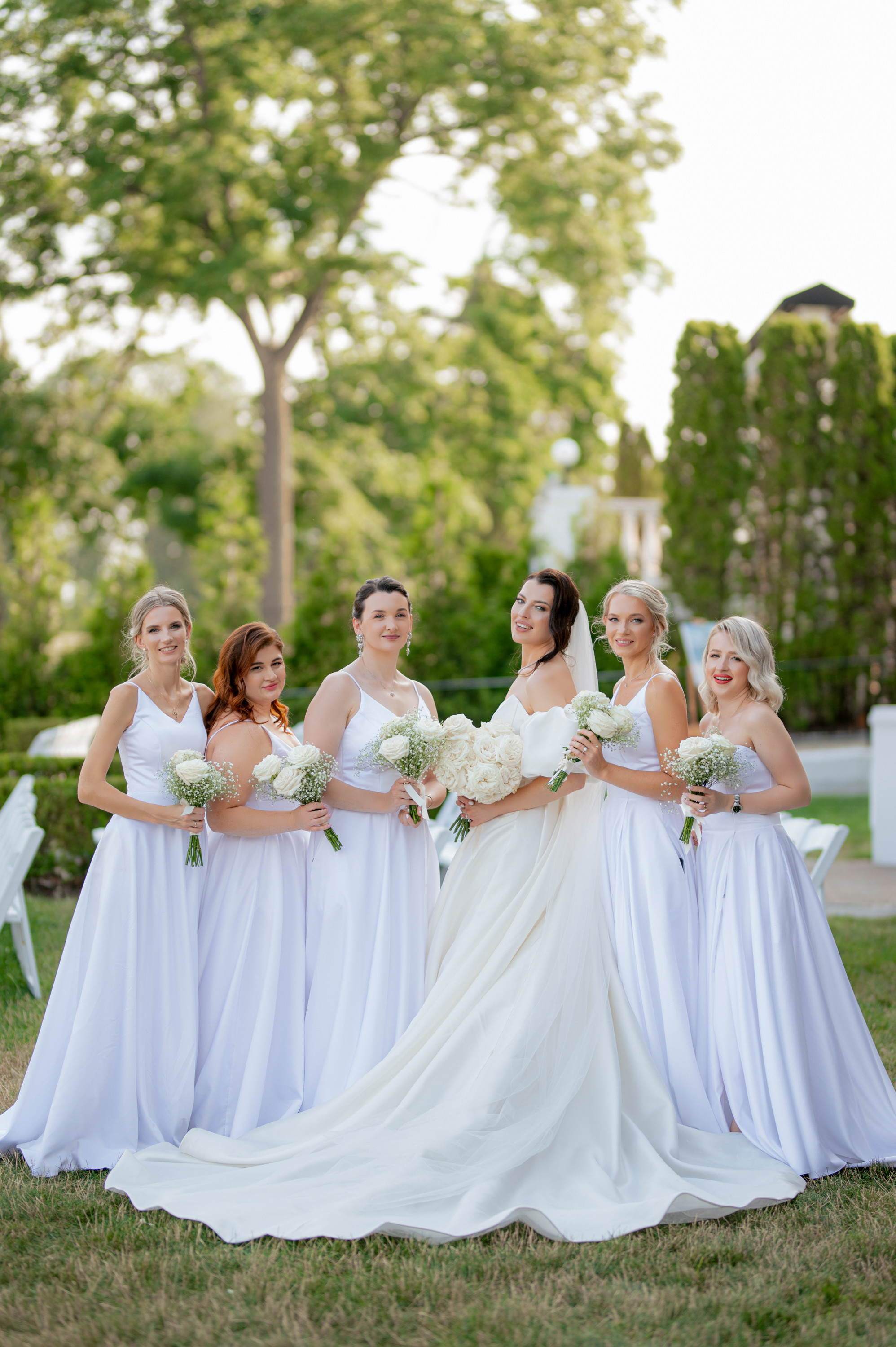 a bride and her bridesmaids pose for a photo