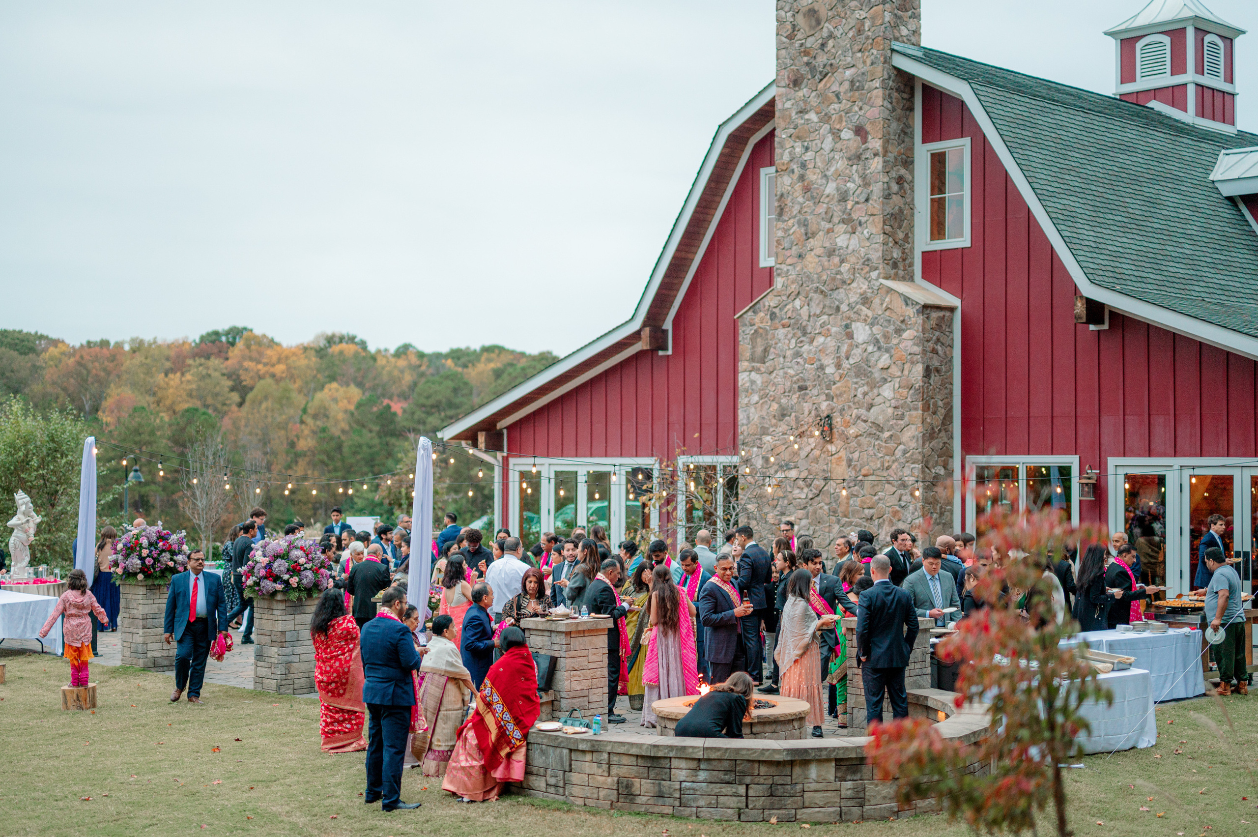 a group of people standing around a fire pit