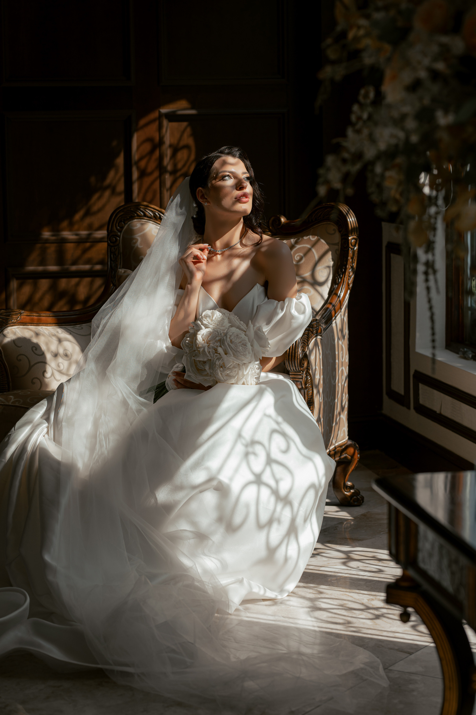 a woman in a wedding dress sitting on a couch