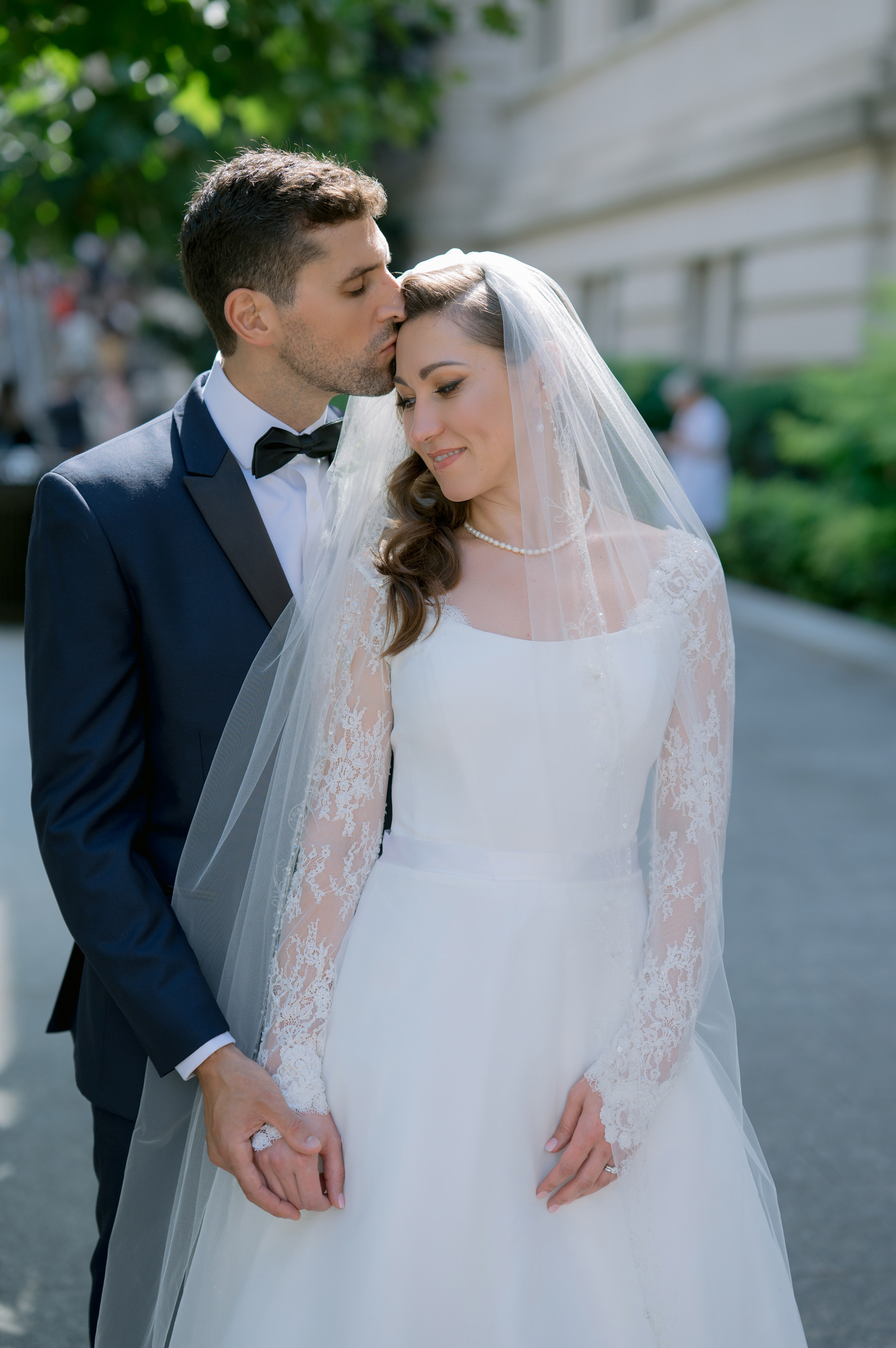 a bride and groom pose for a photo