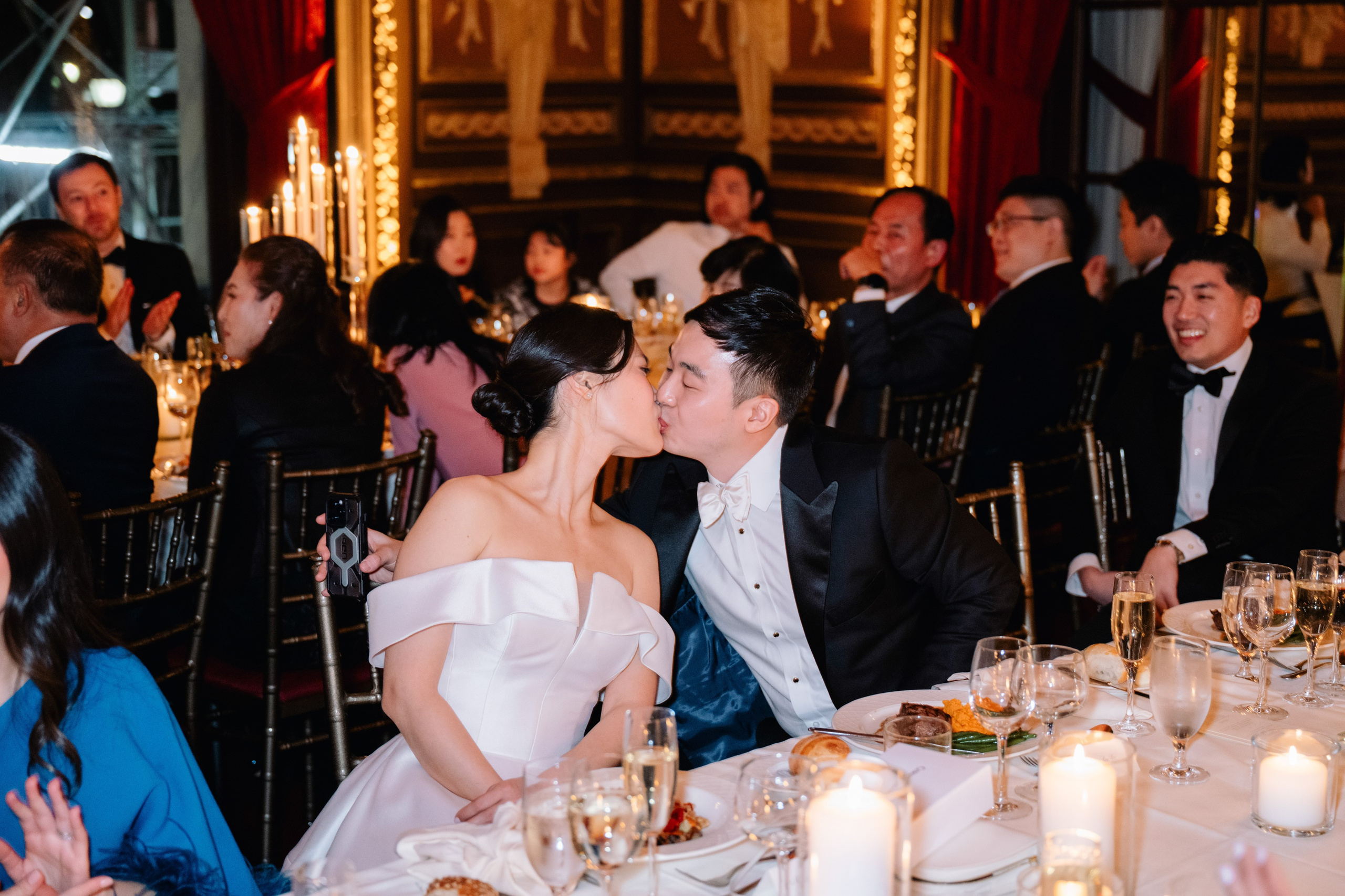 a couple kissing at a wedding reception