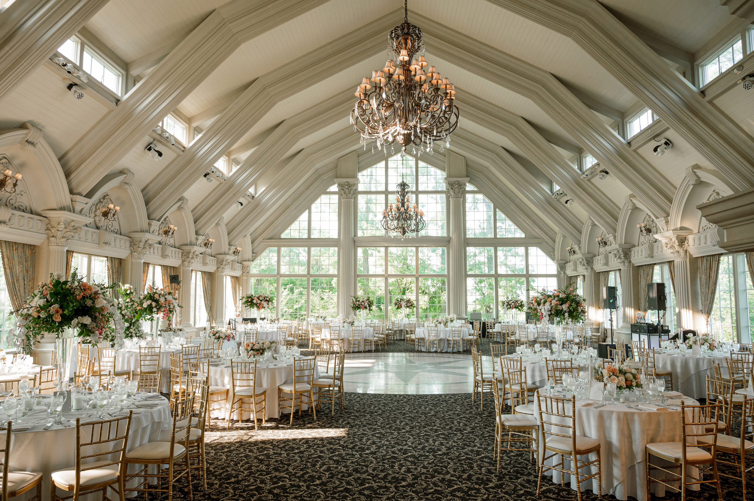 a large room with a chandel and a chandel