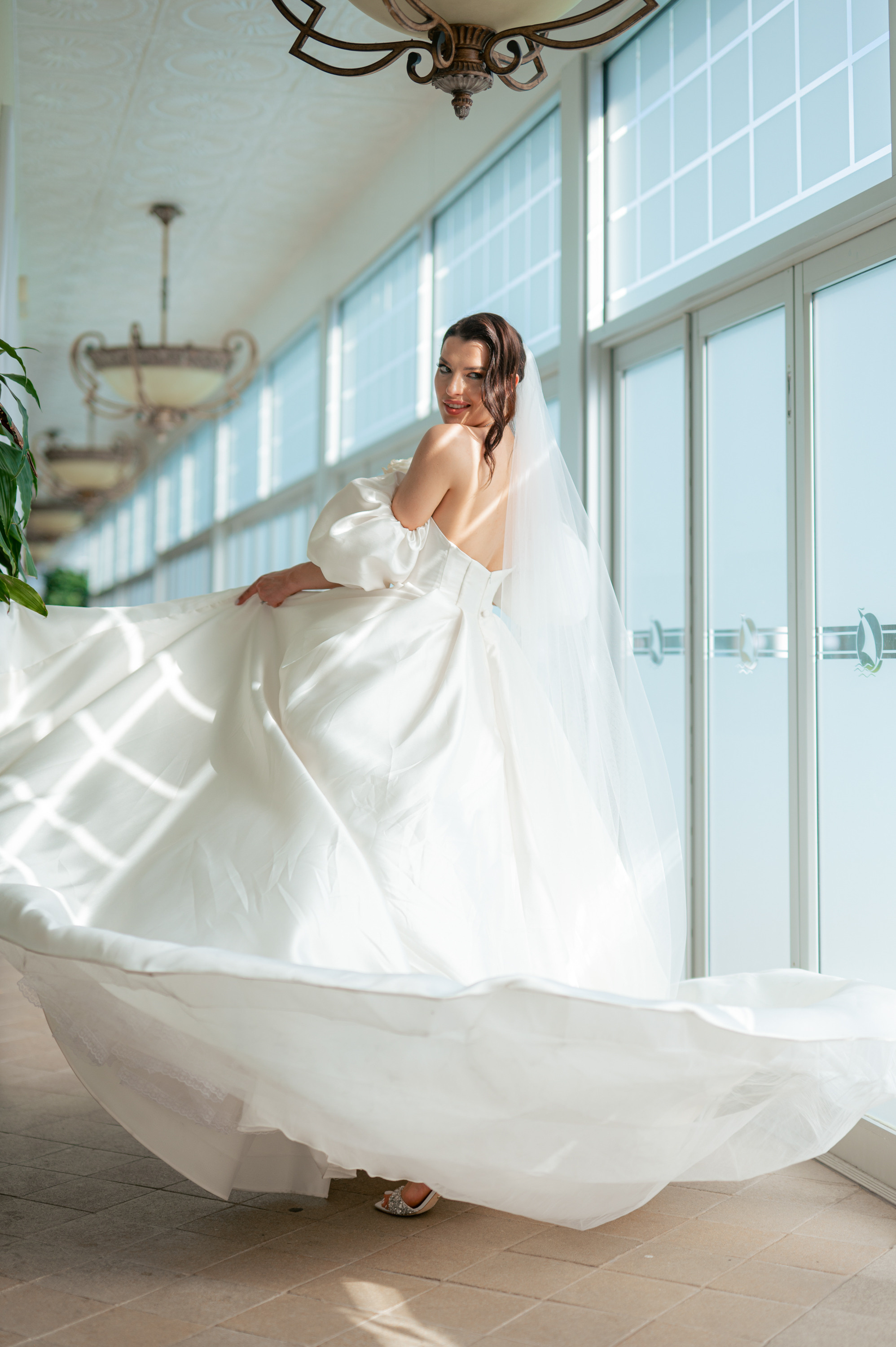 a bride in a white dress is posing for a photo