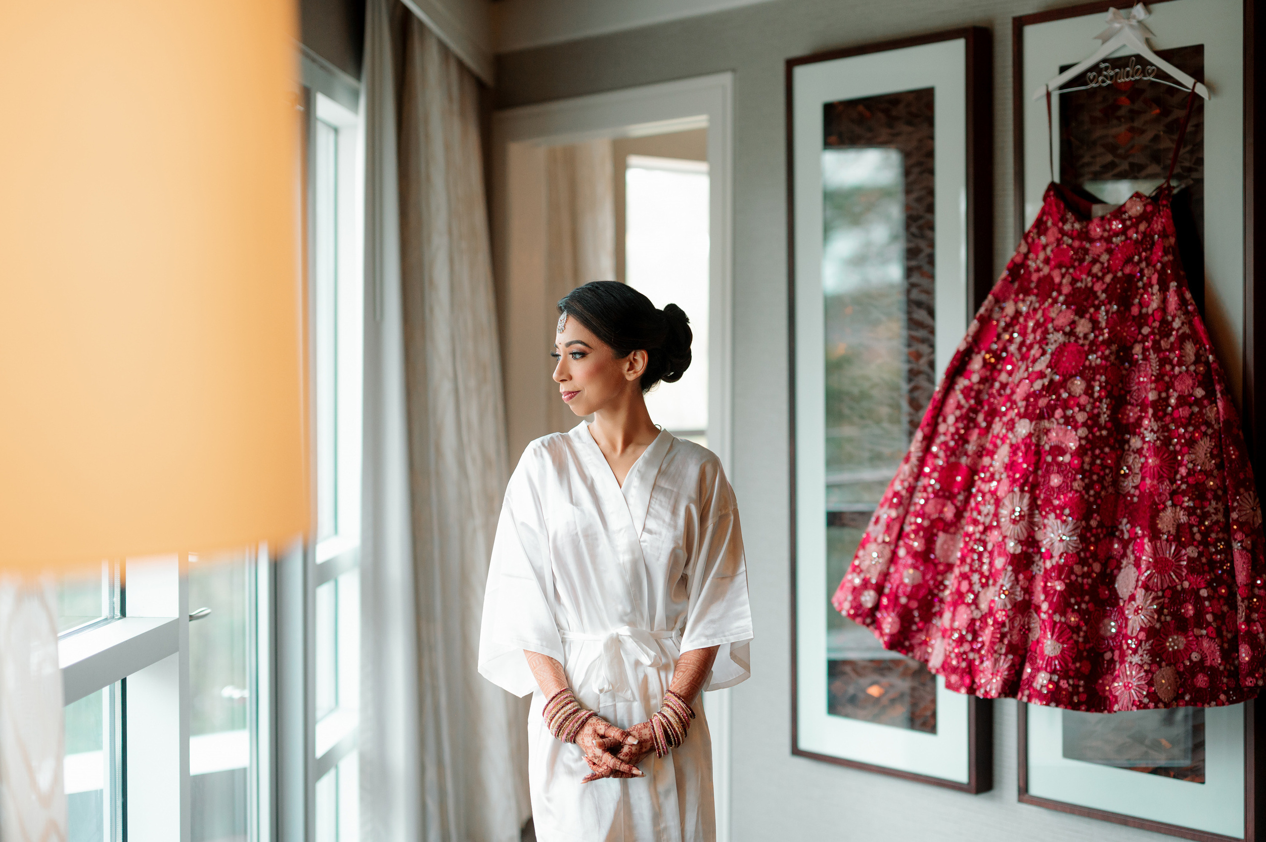 a woman in a robe standing in front of a window