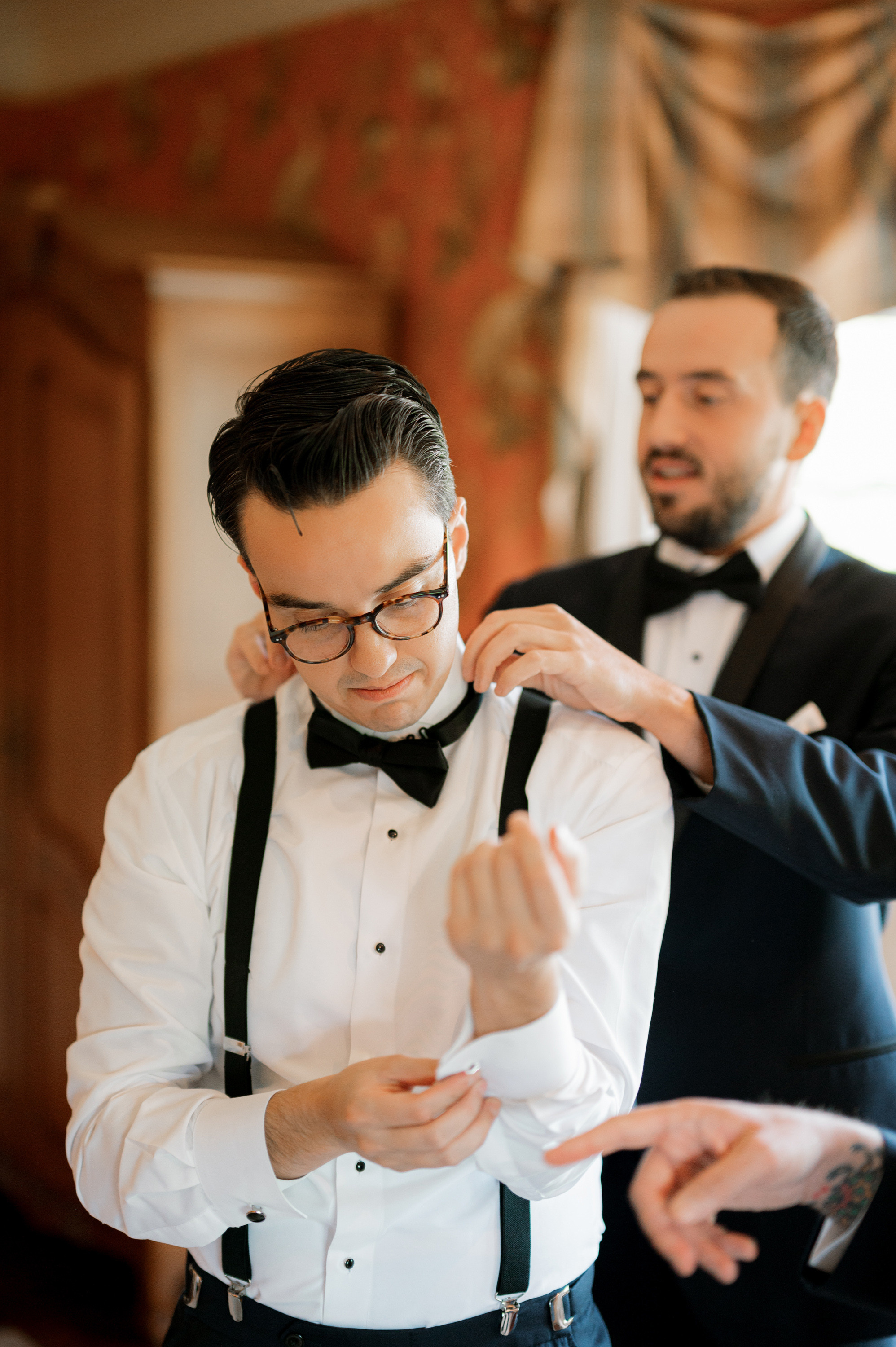 a man in a tuxed suit and bow tie