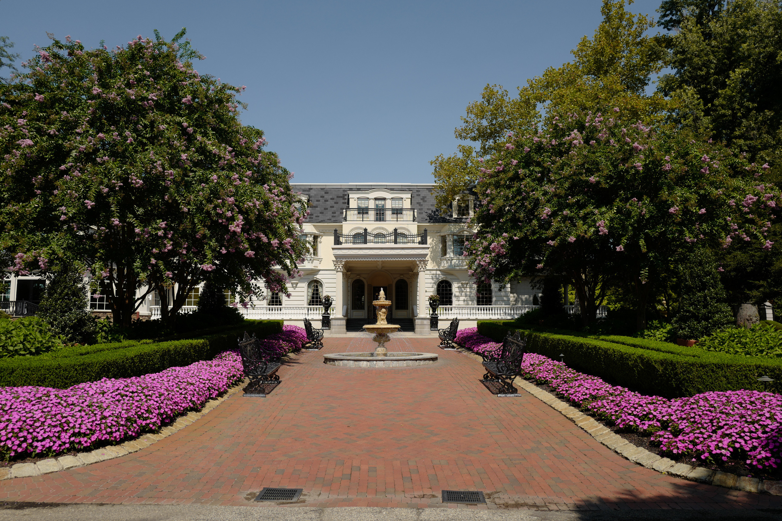 a large house with a large garden and a brick walkway