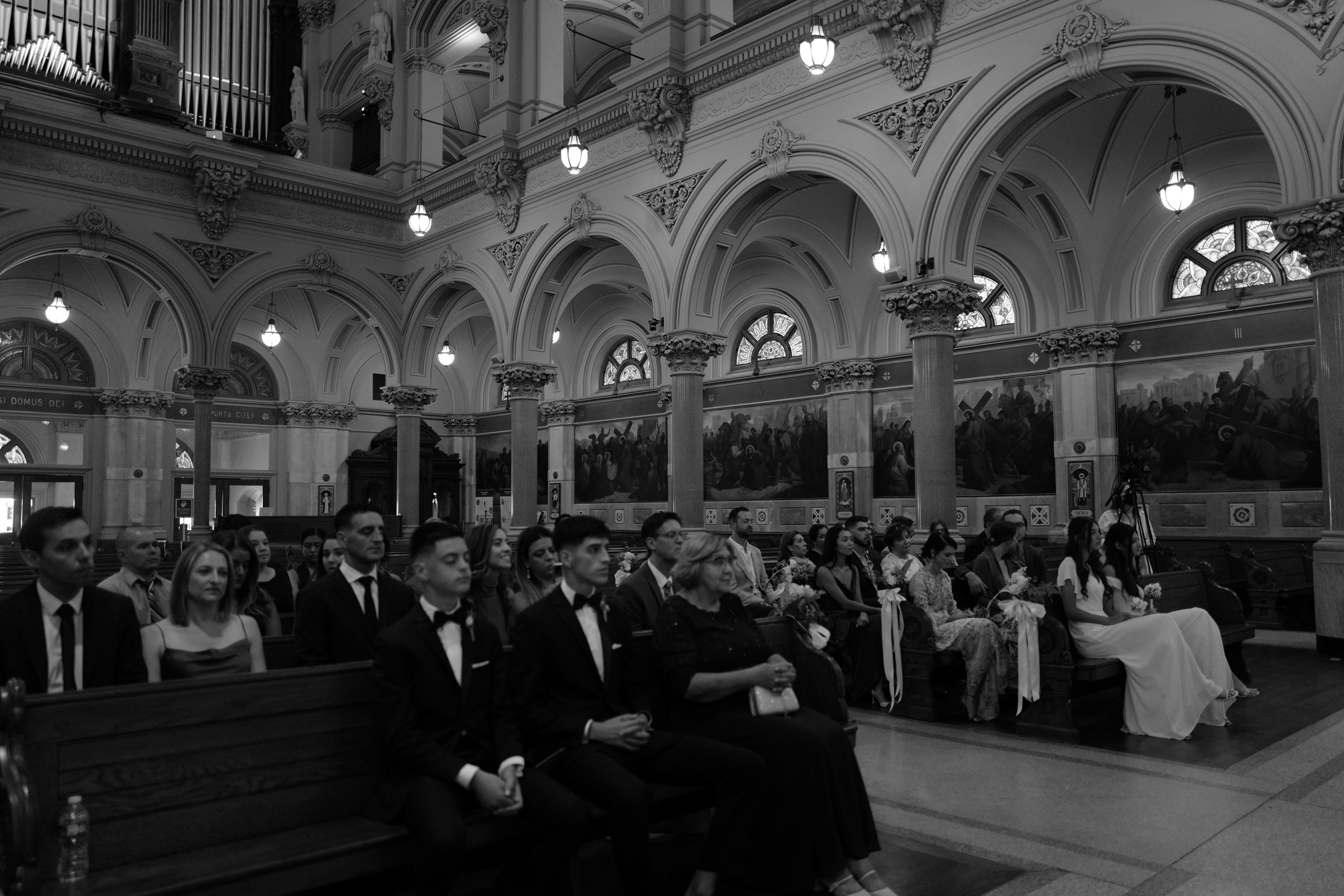 a couple sitting on a bench in a church
