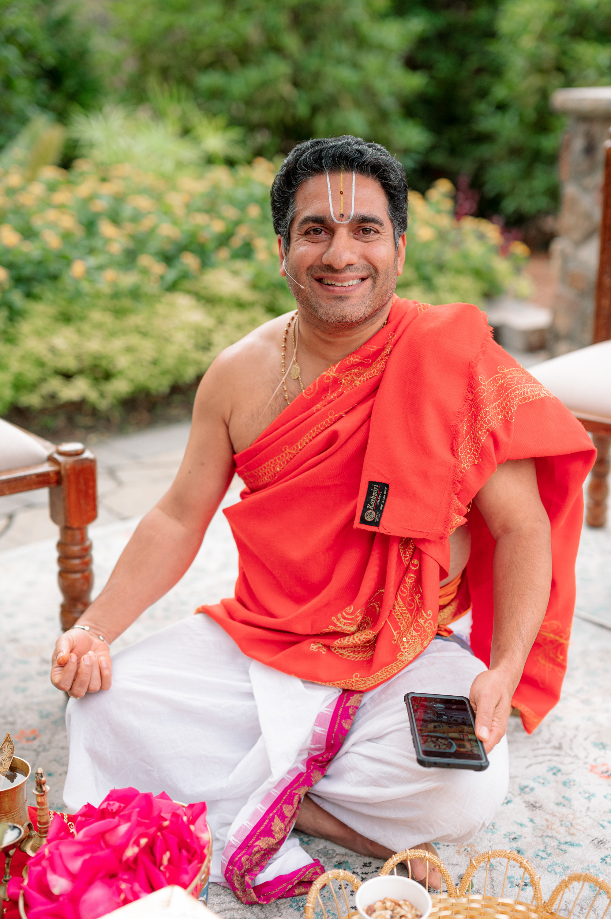 a man in a red shirt sitting on a chair