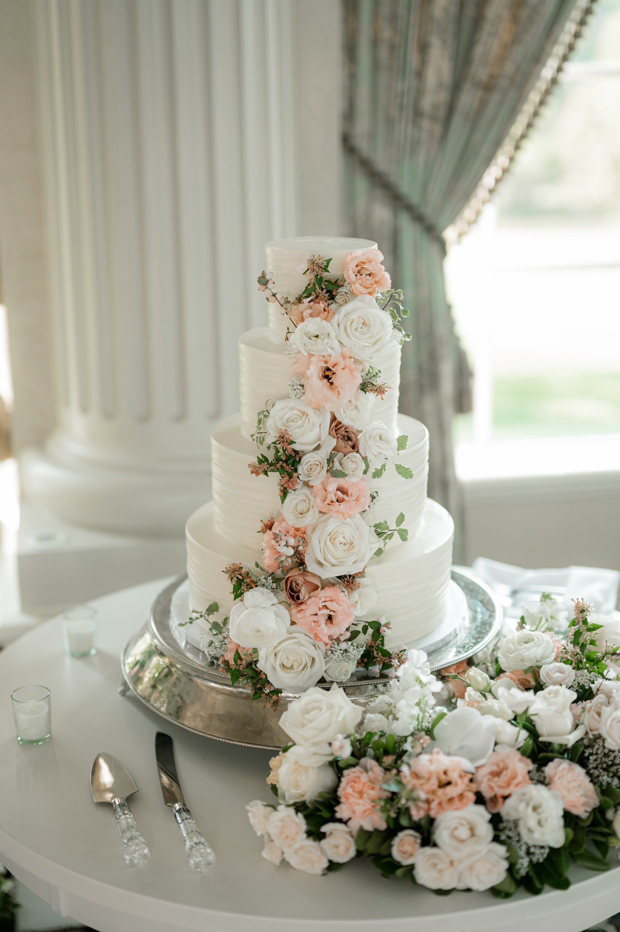 a white cake with pink flowers on top