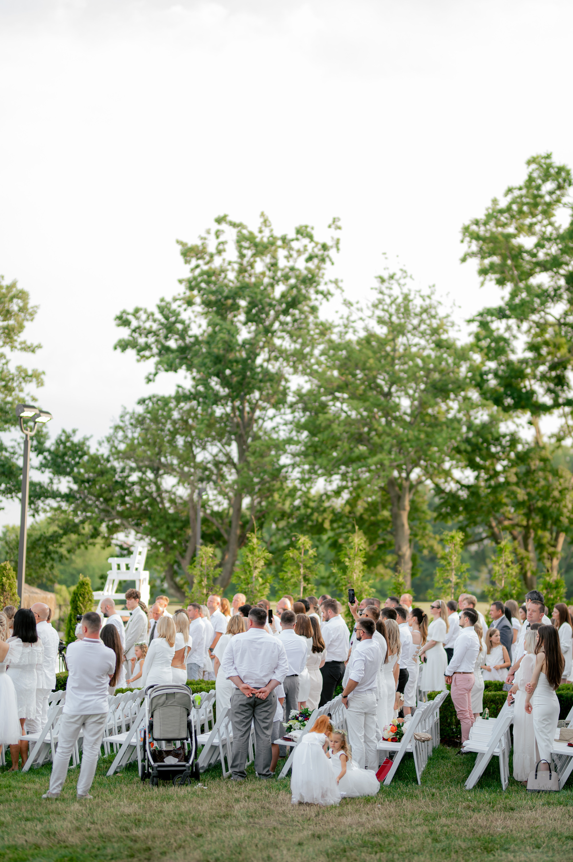 a group of people sitting in chairs in a field