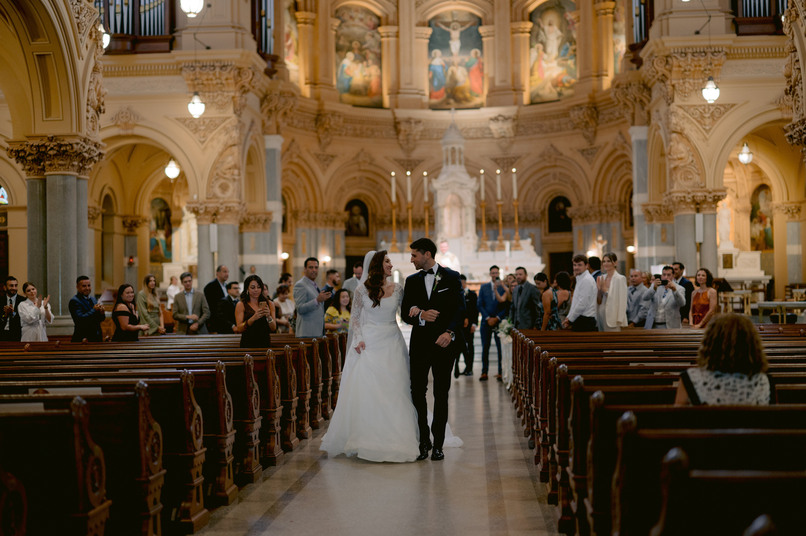 a bride and groom walking down the aisle at their wedding