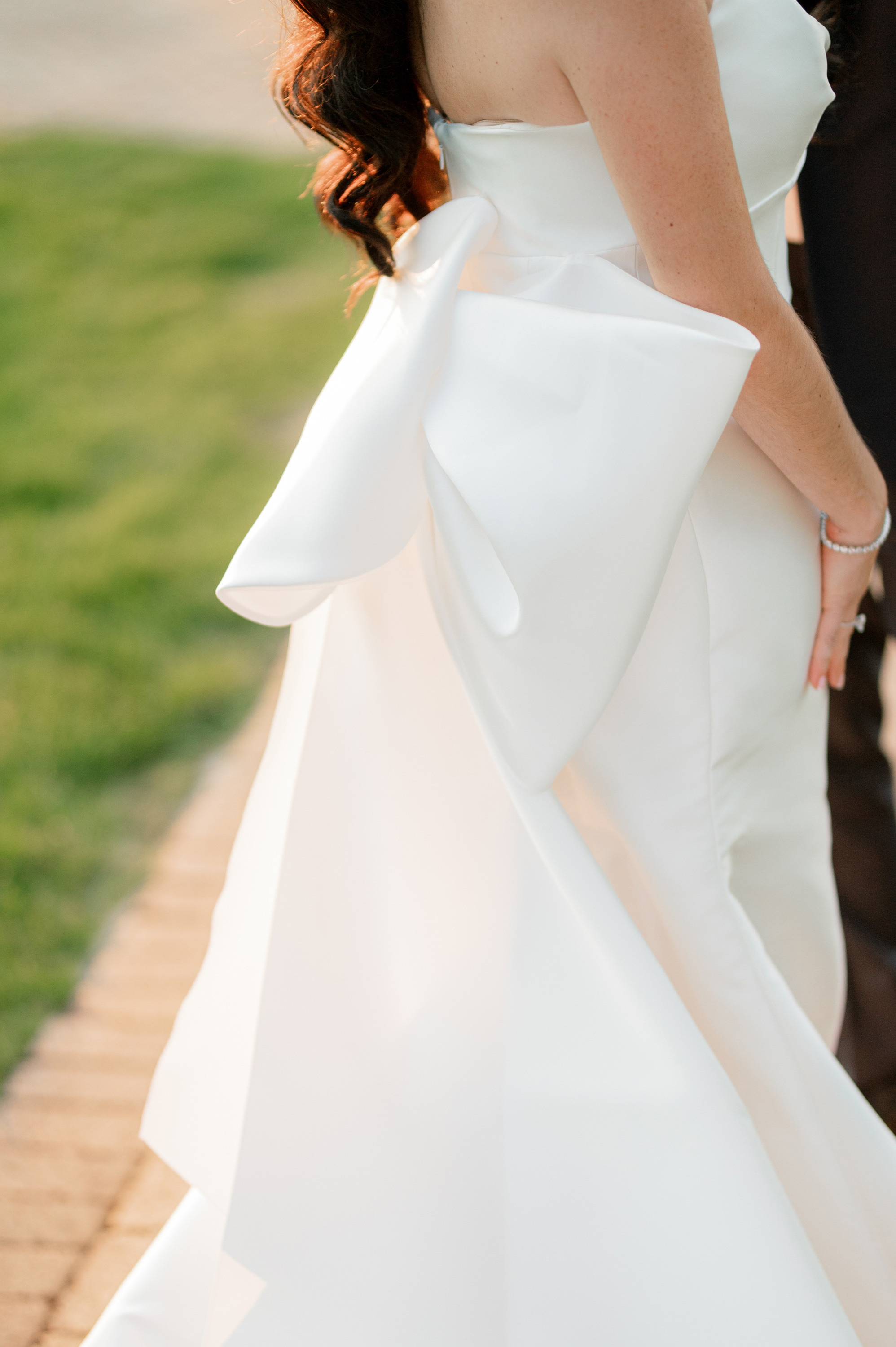 a bride and groom walking down the sidewalk
